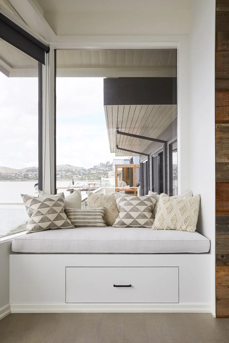 window seat with patterned pillows and bay views