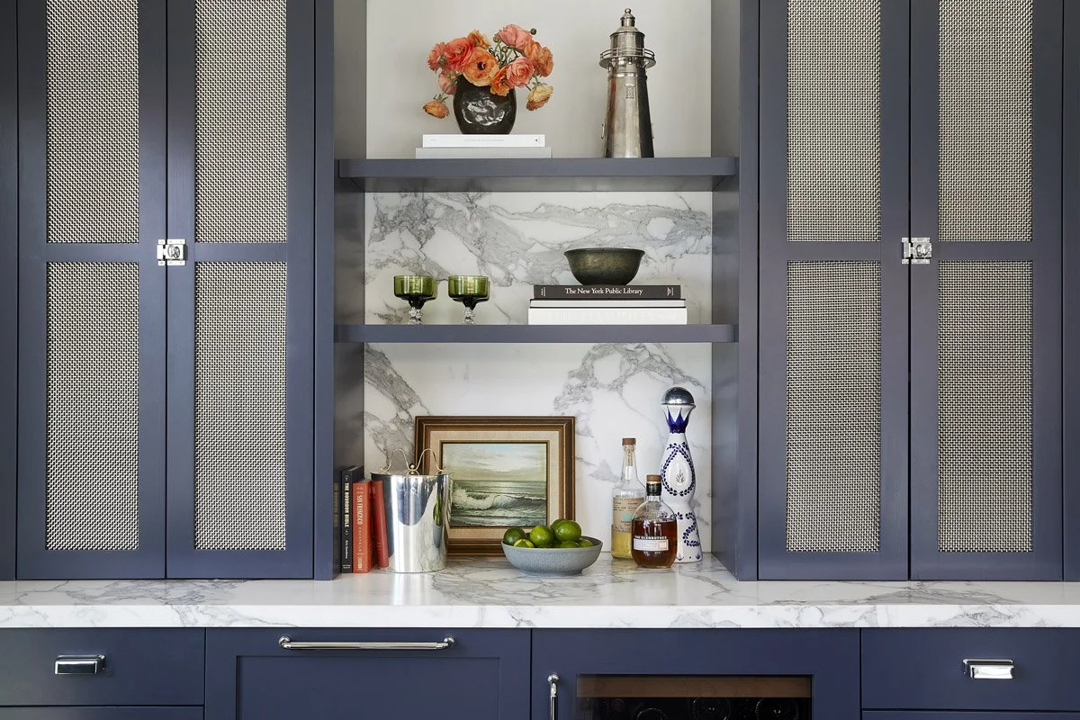 built-in bar with navy cabinetry, mesh doors and floating shelves