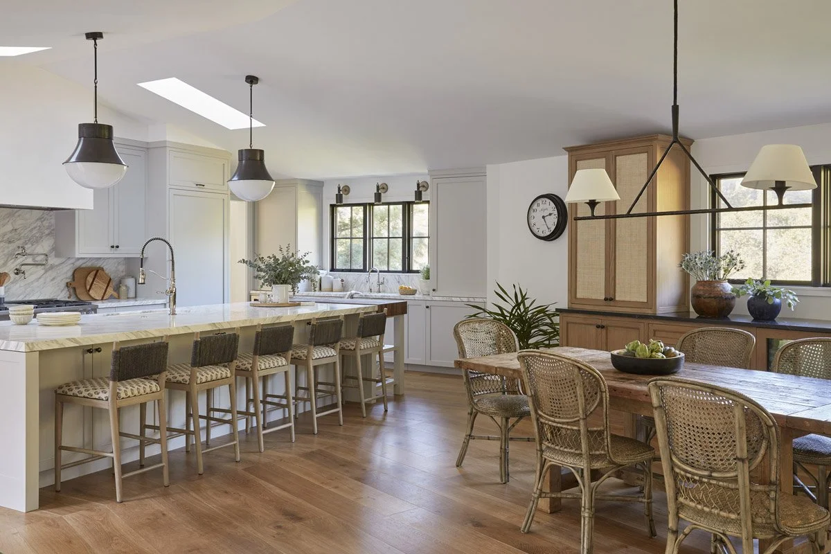 open kitchen and dining area with woven chairs and a white oak hutch