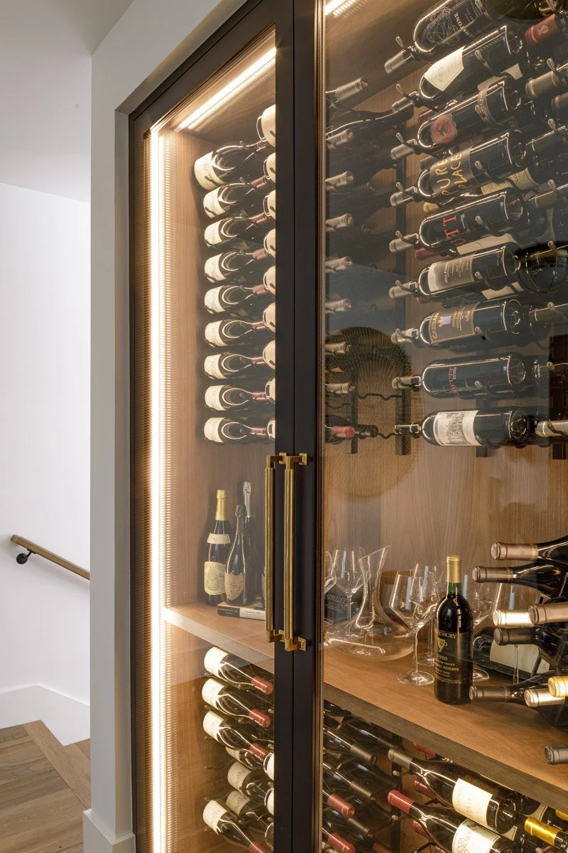 backlit wine room with floor-to-ceiling bottle storage