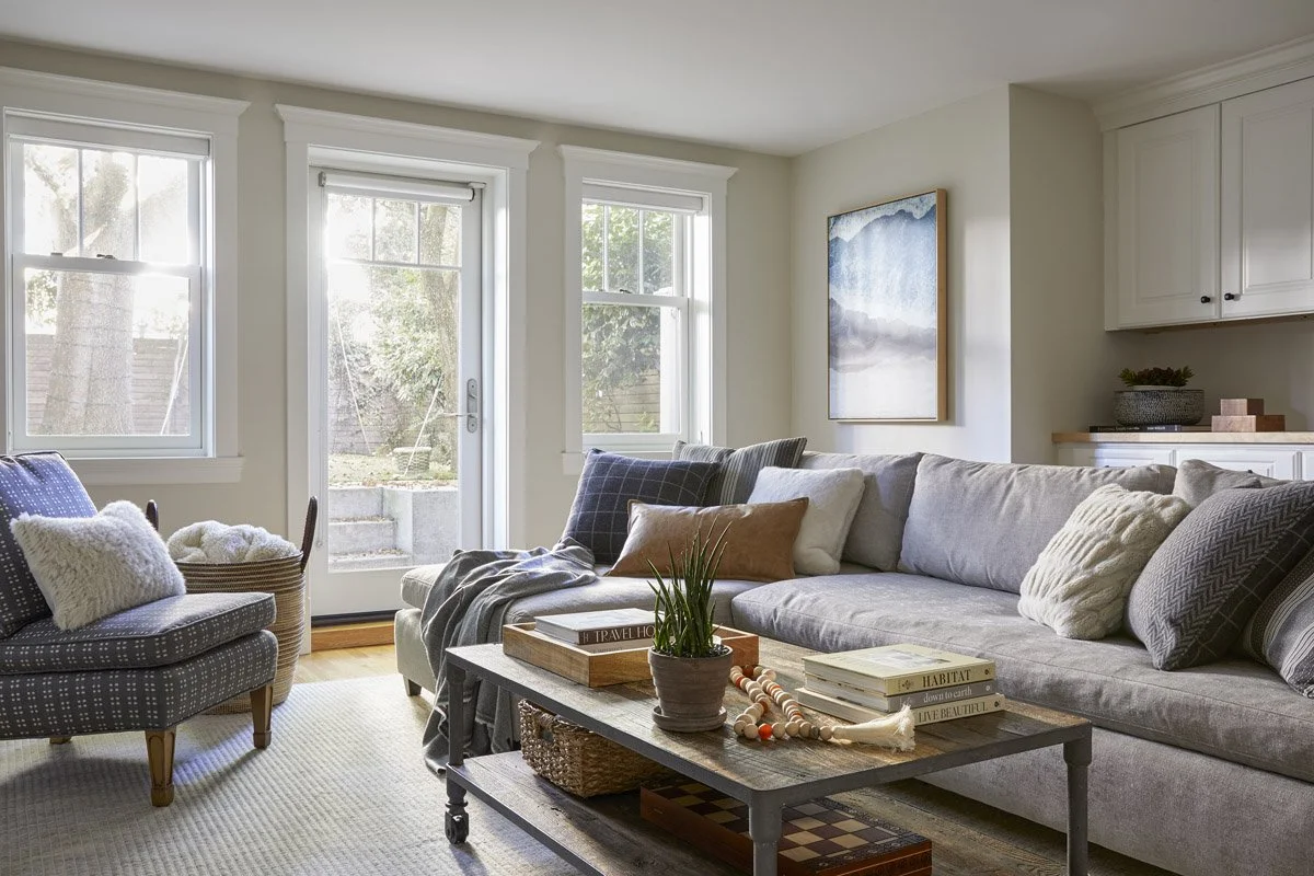 family room with grey sofa, wood coffee table and French doors