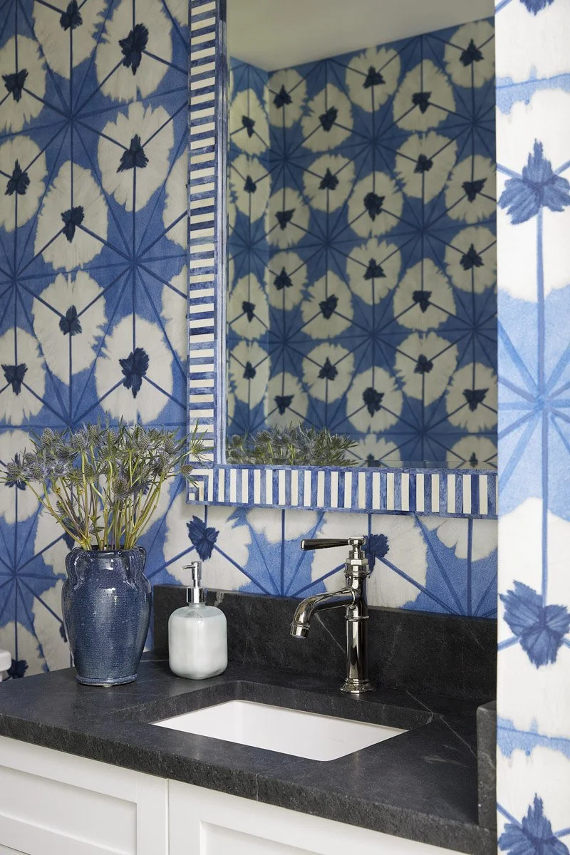 powder room with blue and white shibori wallpaper and black countertop
