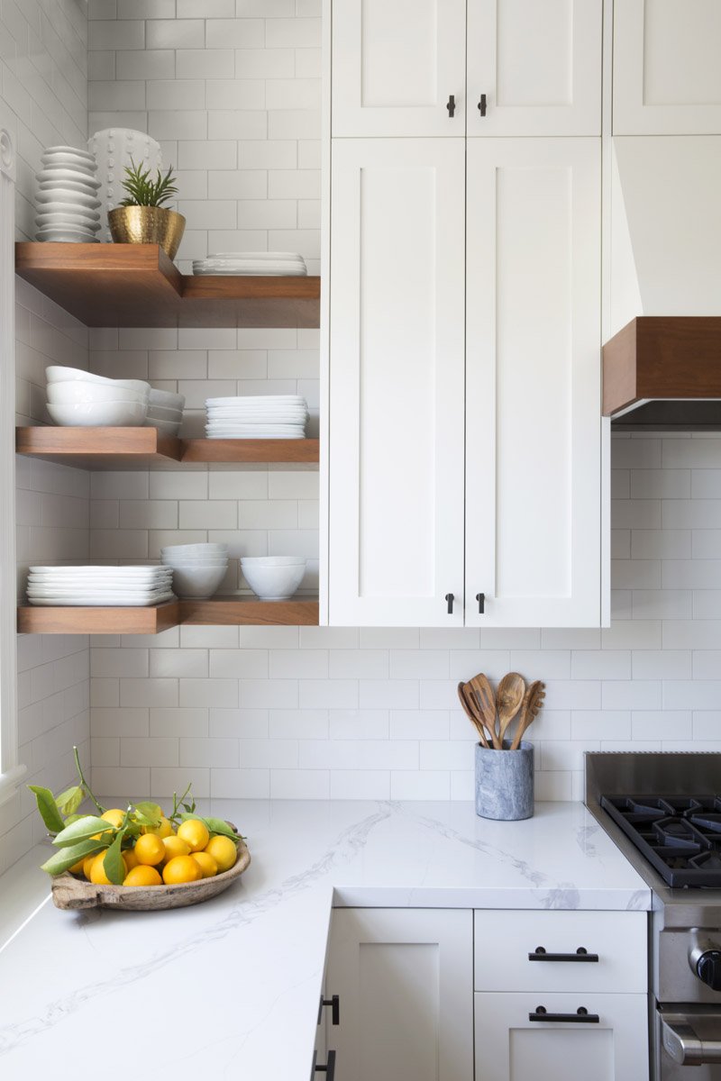 white kitchen with floating walnut shelves and subway tile