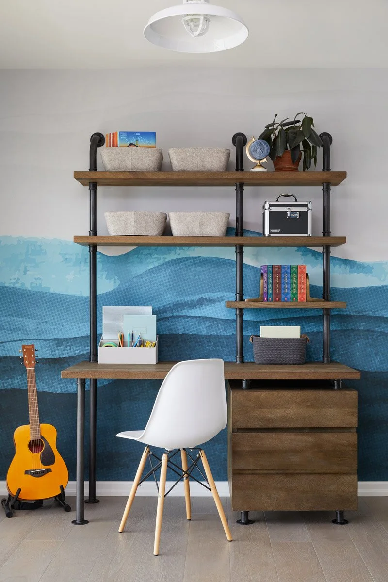 study nook with blue watercolour mural, industrial shelving and white desk chair