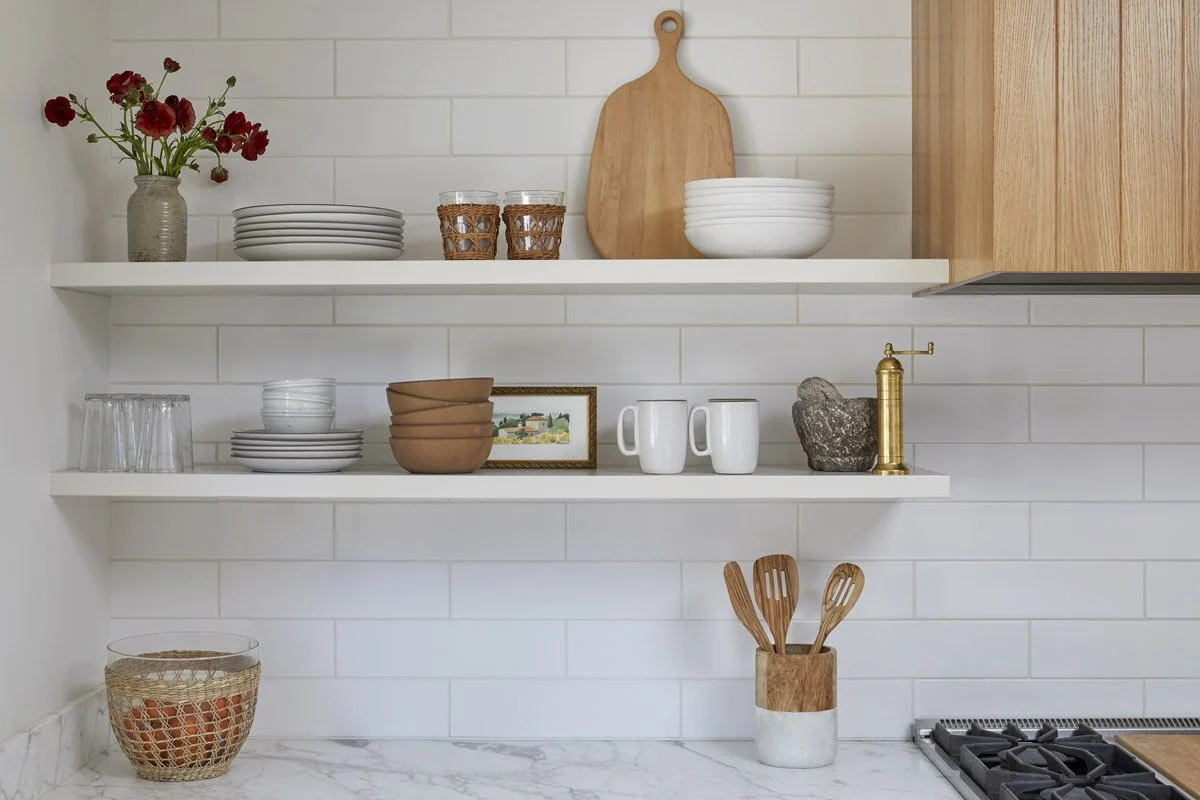 floating kitchen shelves styled with dishes, cutting boards and utensils
