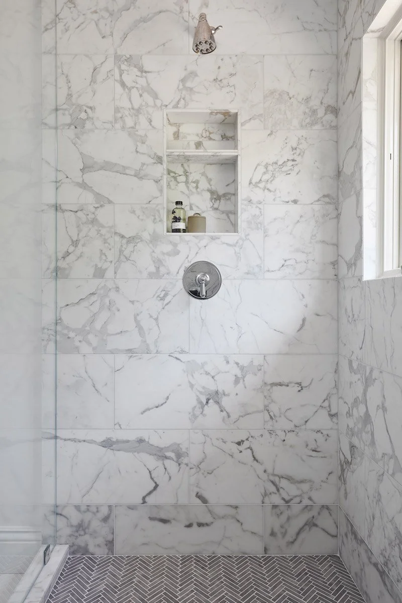 marble walk-in shower with built-in niche