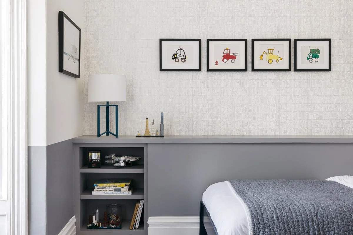 kids bedroom with grey wainscoting, built-in shelving and framed car prints