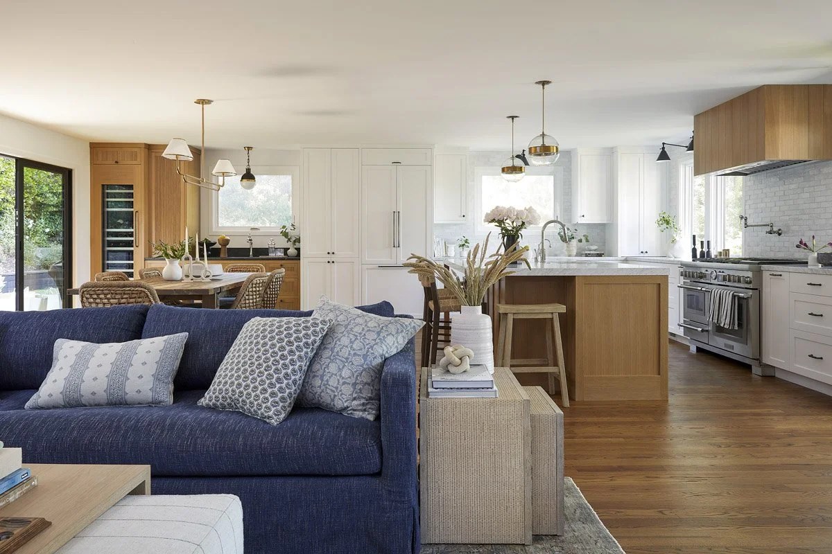 great room with navy sofa flowing into an open kitchen