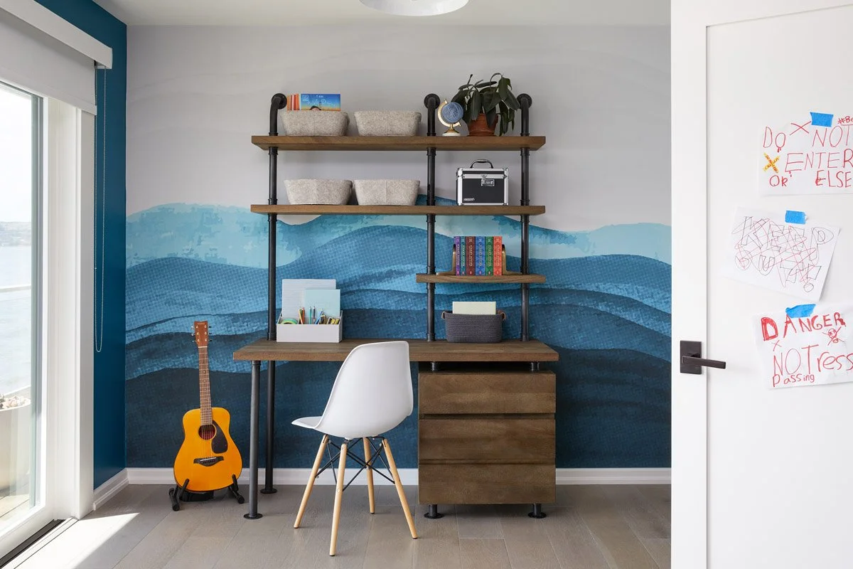 kids study area with wall-mounted desk, open shelving and blue ombre mural