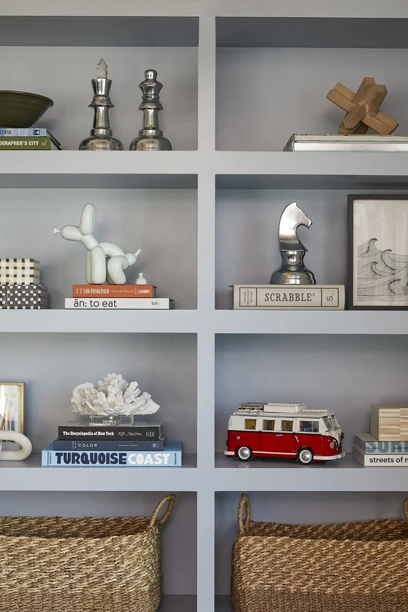 close-up of styled built-in shelves with woven baskets and decorative objects