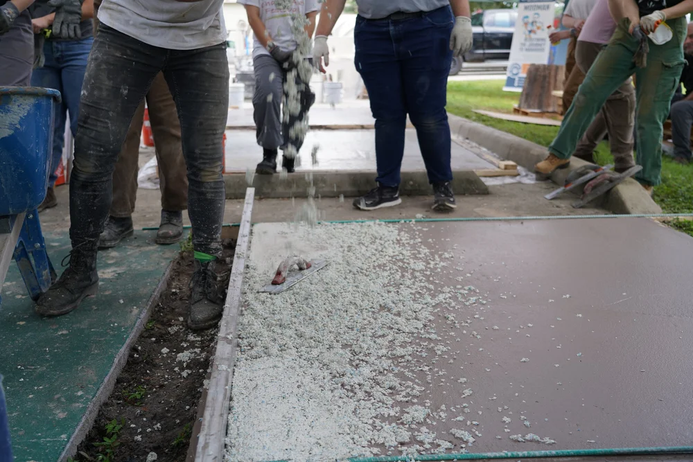 Students lay down firmecrete engeneered overlay in a wet-onwet application .JPG