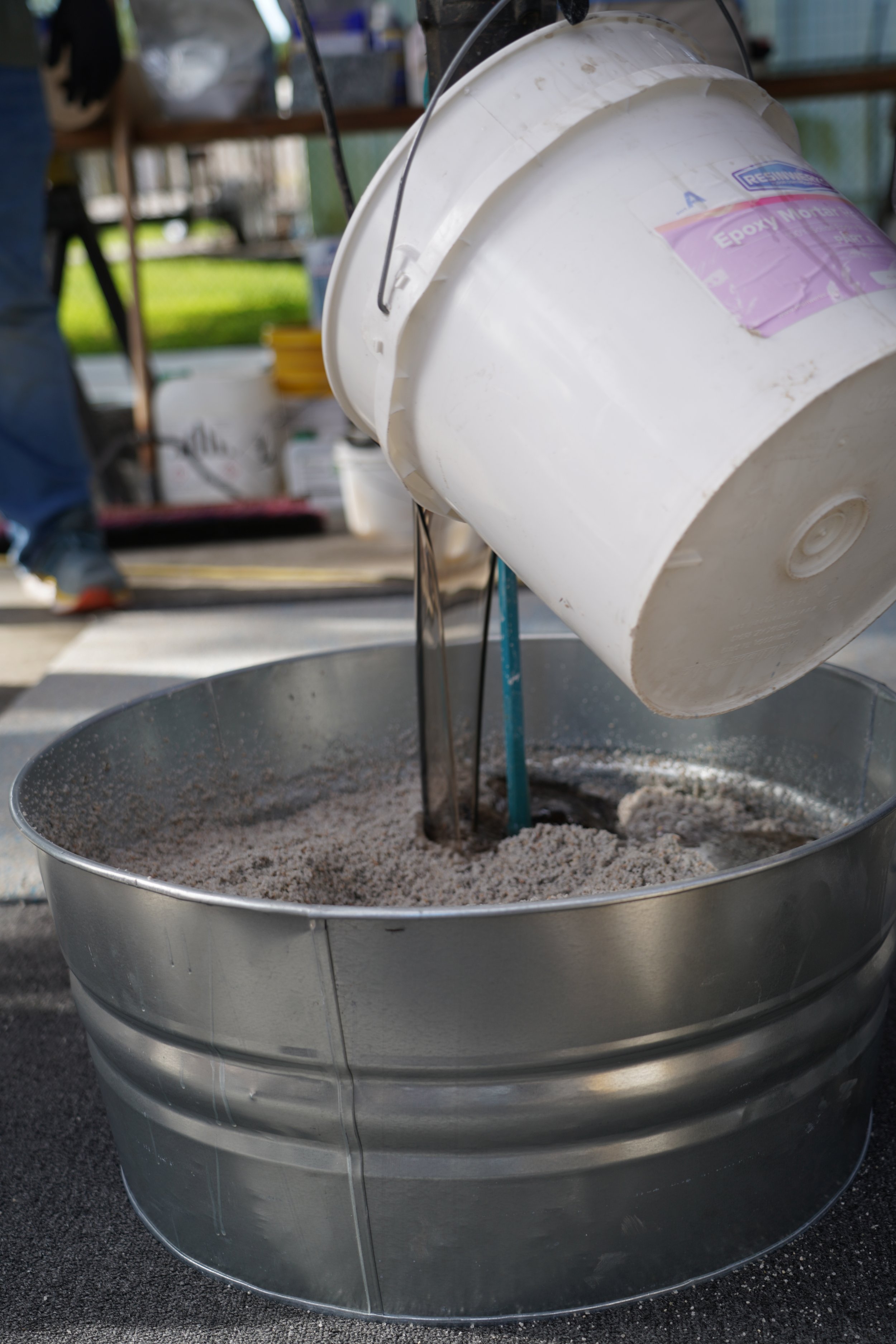 Students mix Resinwerks eppoxy mortar in tin resin bucket.JPG