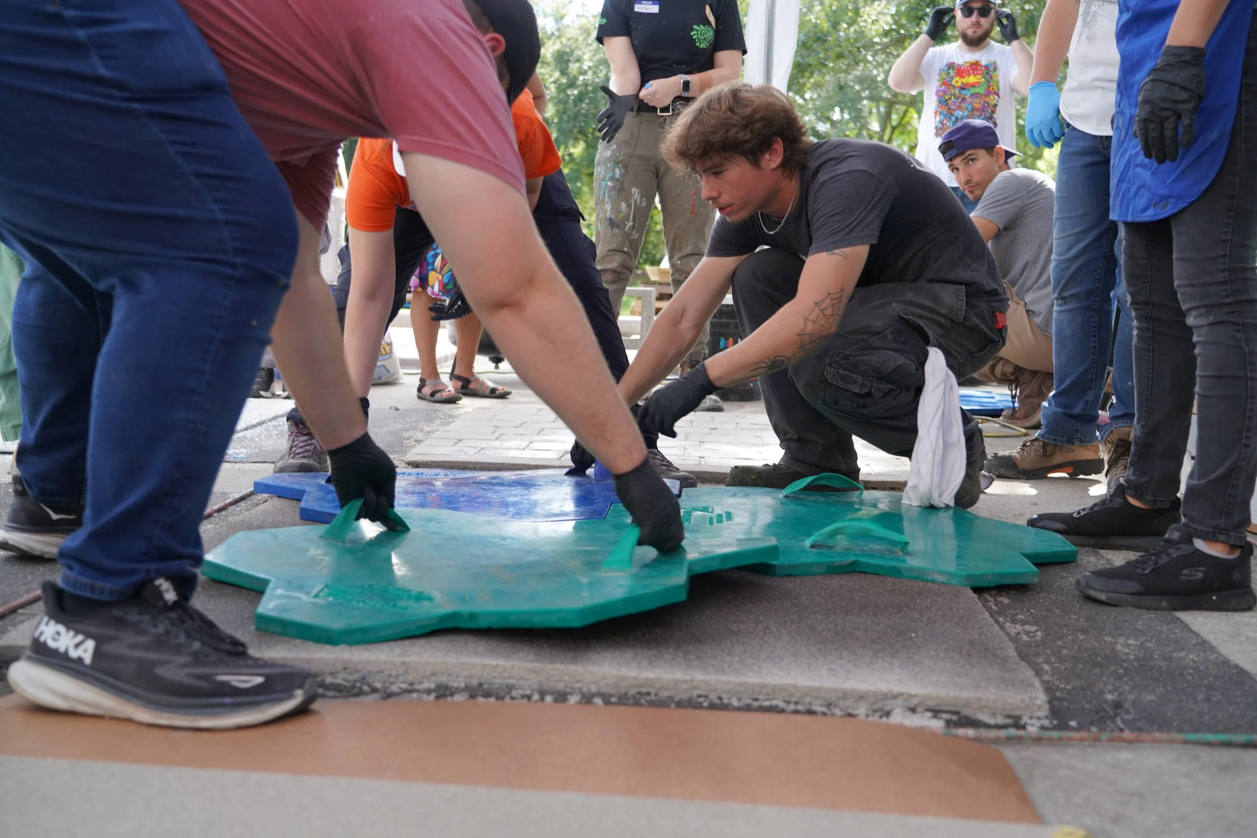 Students use texture mats to imprint on Resinwerks stamped epoxy mortar system.JPG