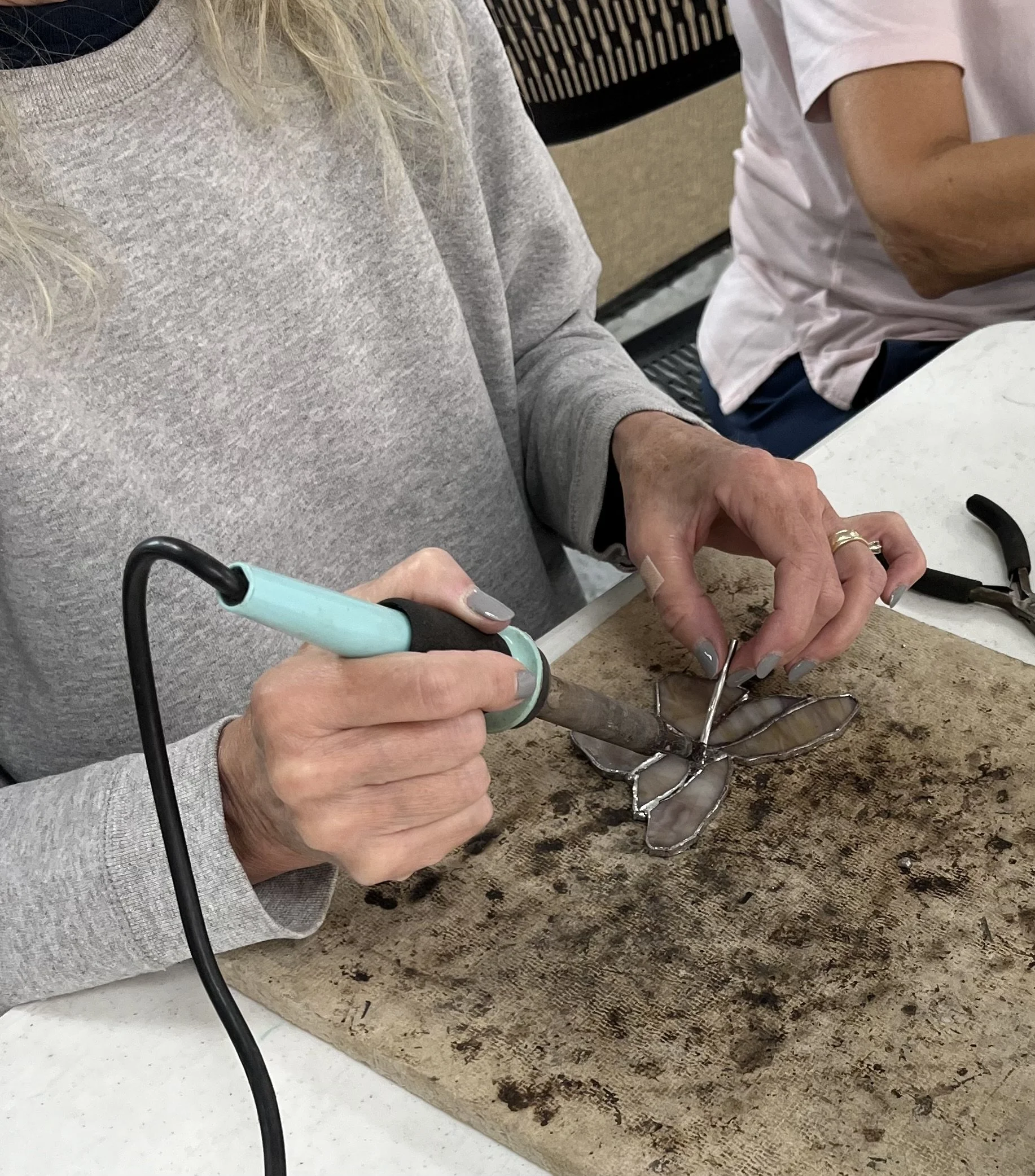 Student soldering her project Kim S Joy.jpg