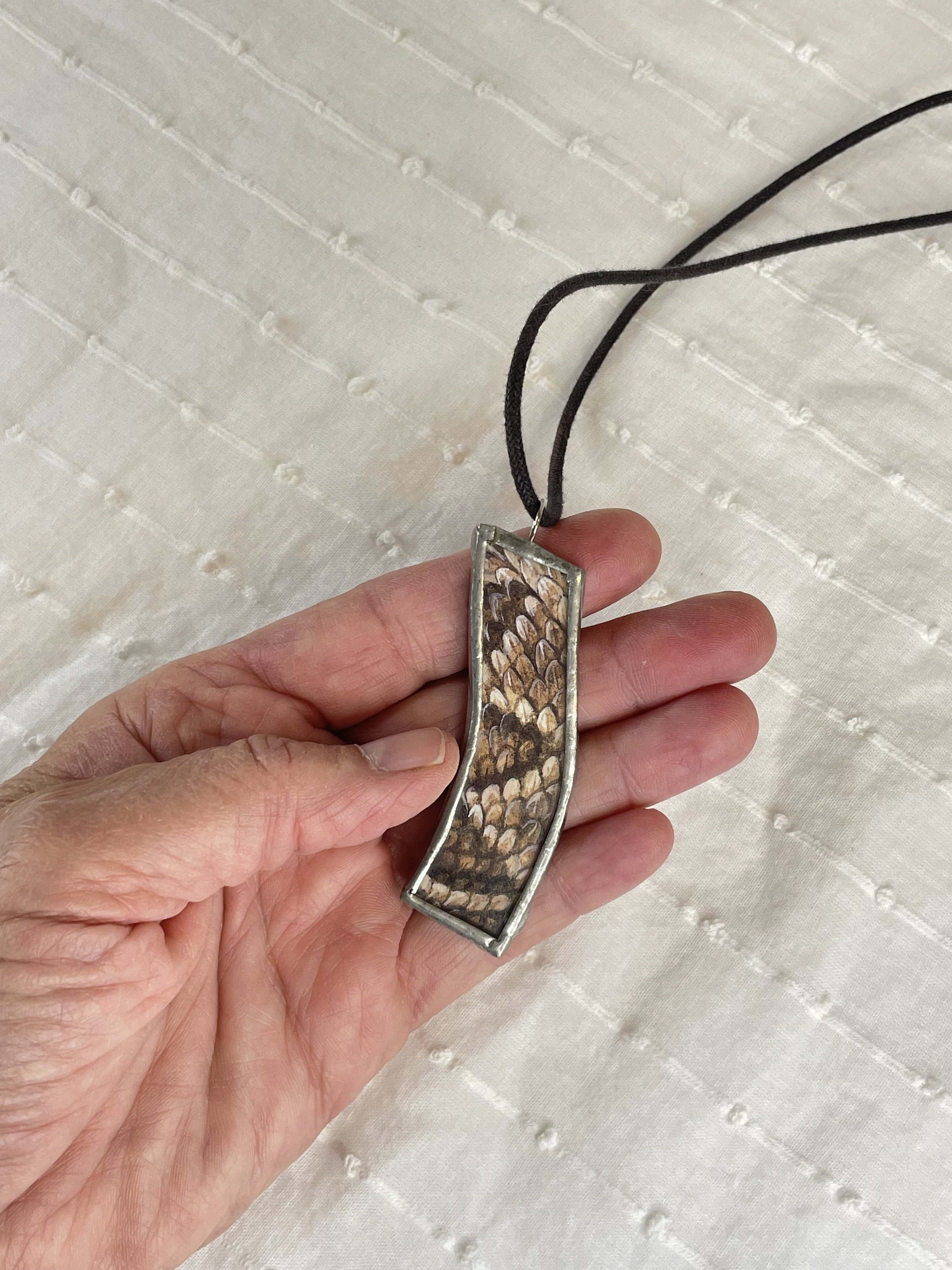Snakeskin Reversible Pendant Brown Side in my hand Kim S Joy.jpg