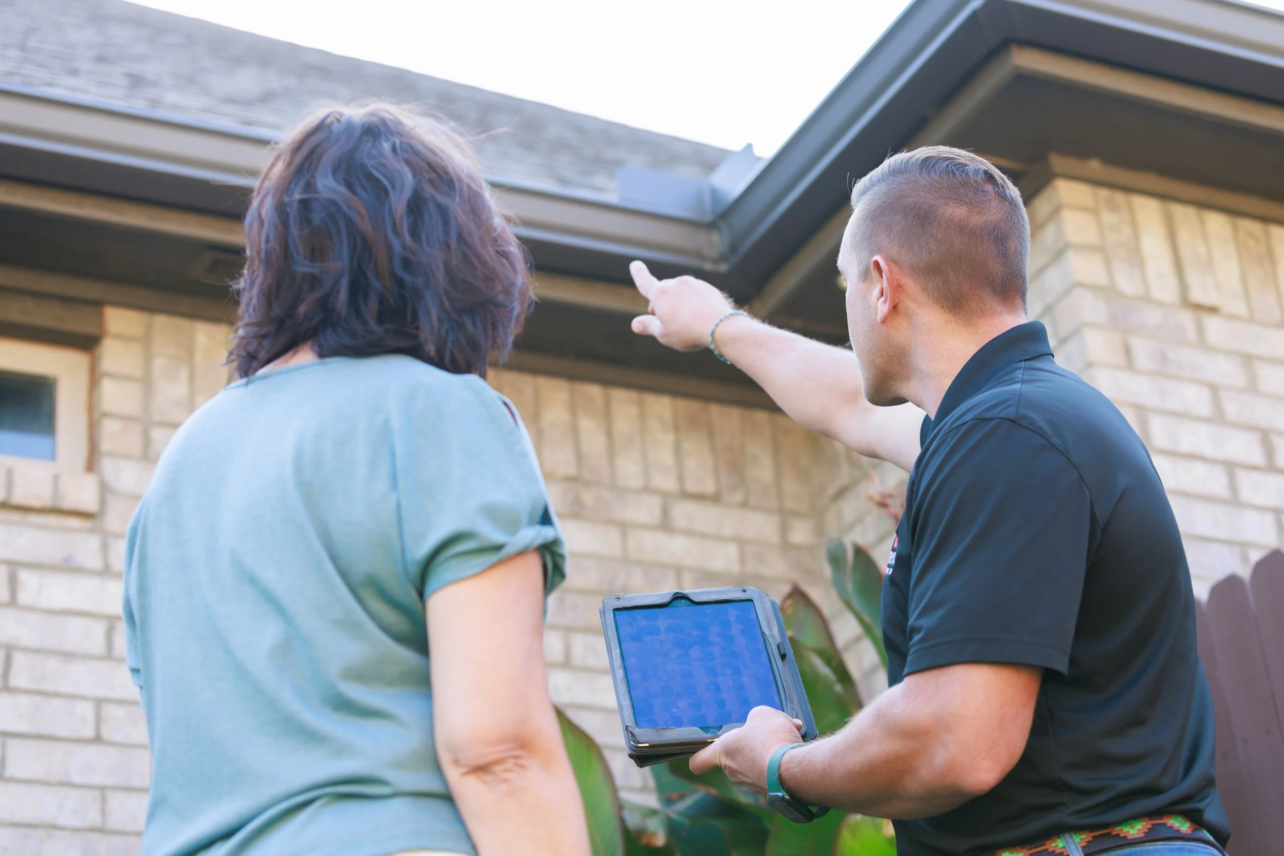 Red River Roofing employee speaking with a customer
