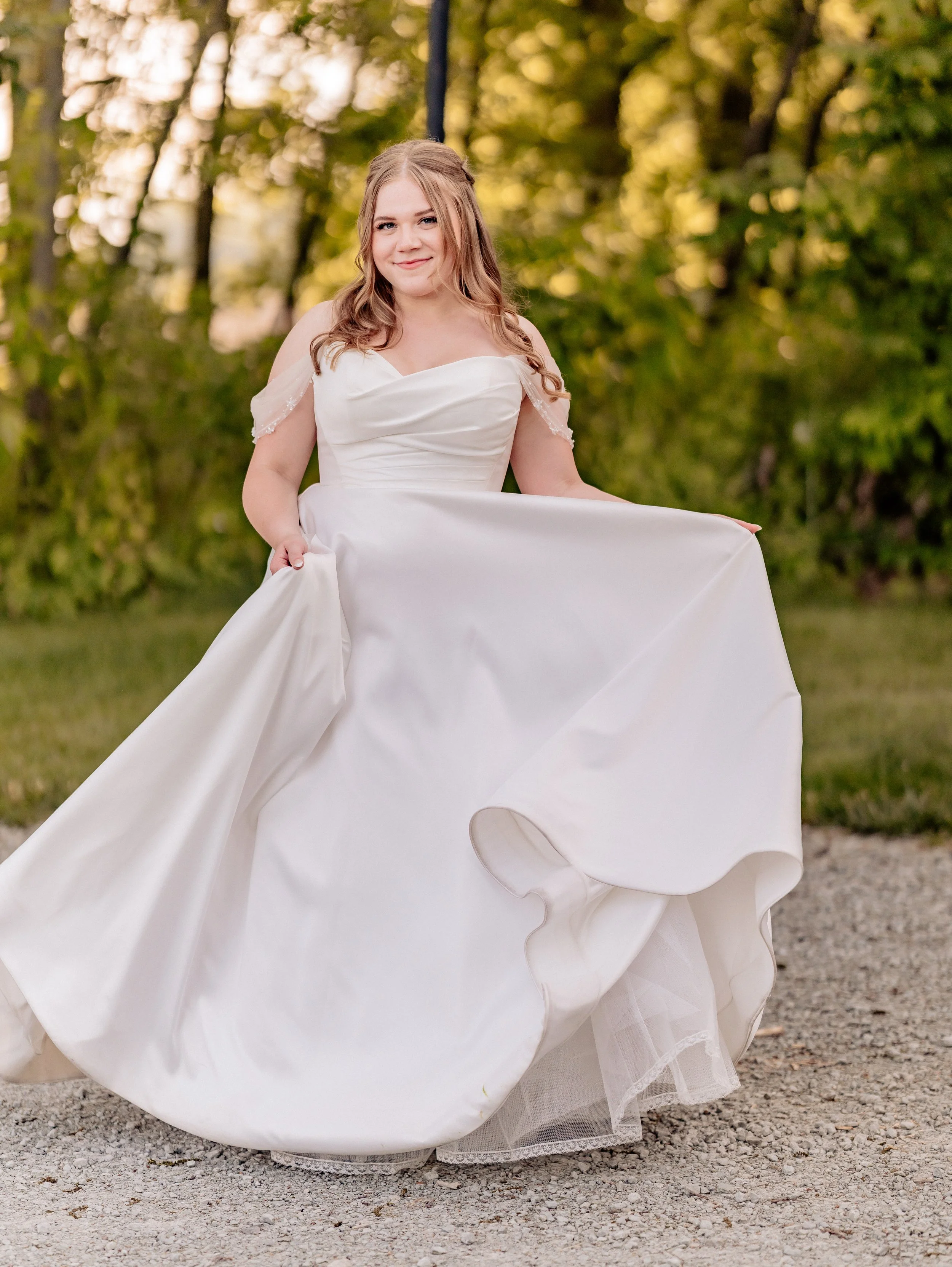 bride dances with dress in sunset