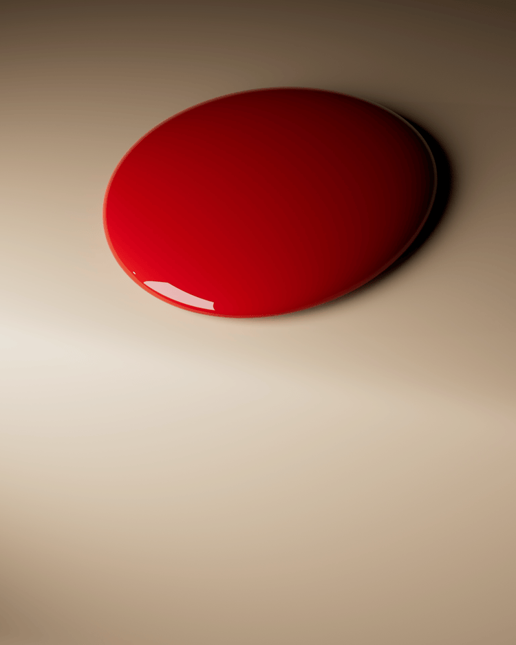 A shiny red lipgloss or lipstick drop smears across a beige background.