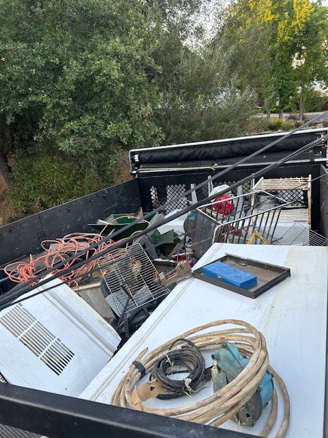 Load of miscellaneous tools and equipment, including extension cords, a tray, and a piece of machinery, in Martinez, CA