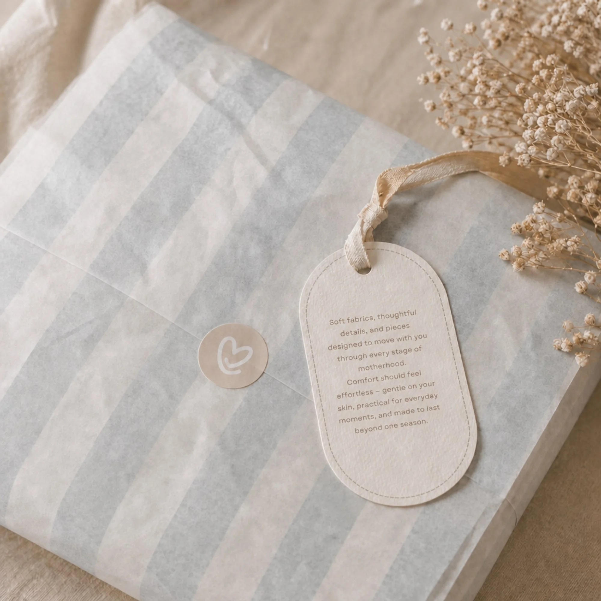 Brand packaging and visual identity design for Majka motherhood clothing brand featuring premium paper textures and editorial packaging details.