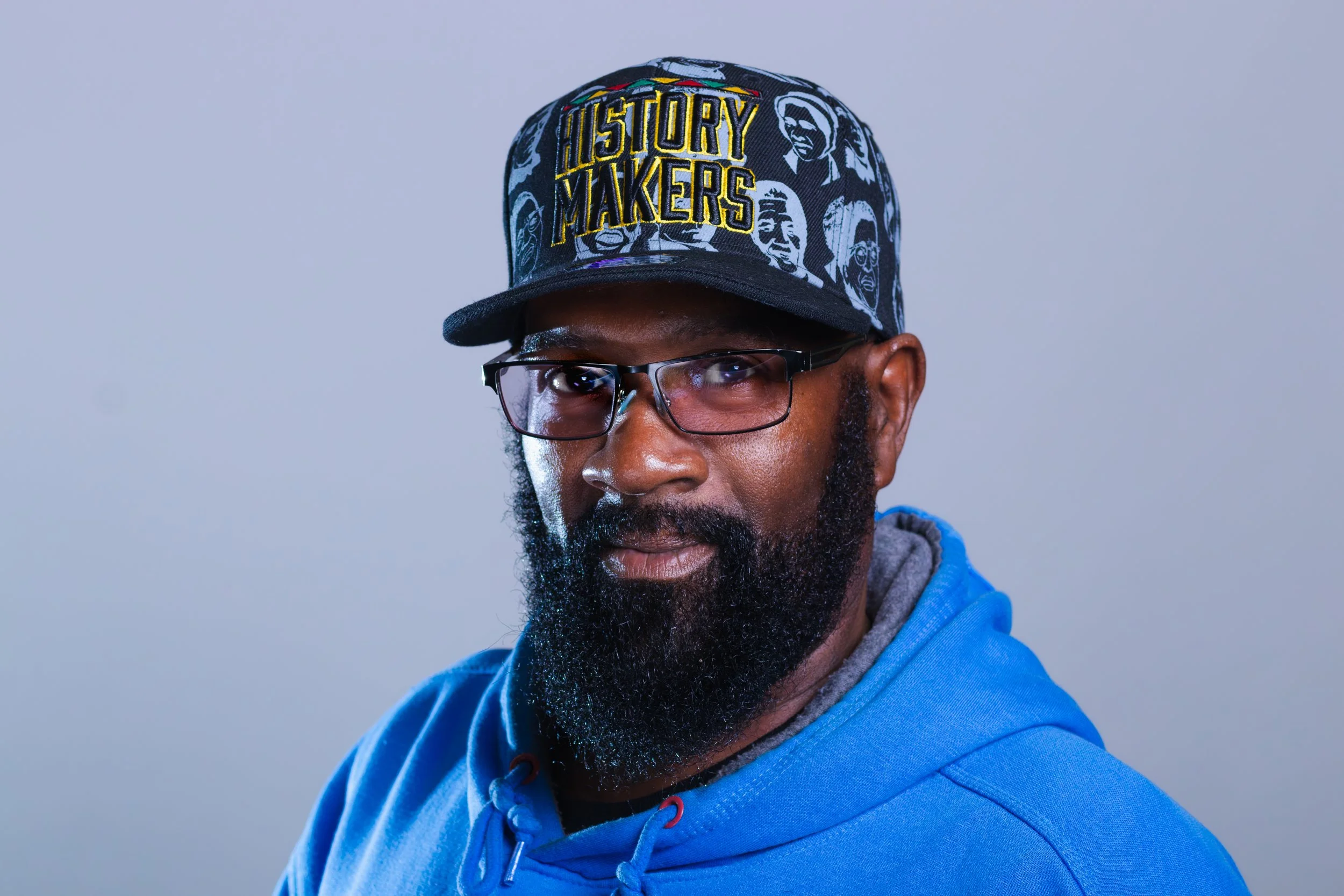 Close-up headshot of Ernest Hightower, Member of the NACD Board of Directors, smiling warmly, against a warm grey background.