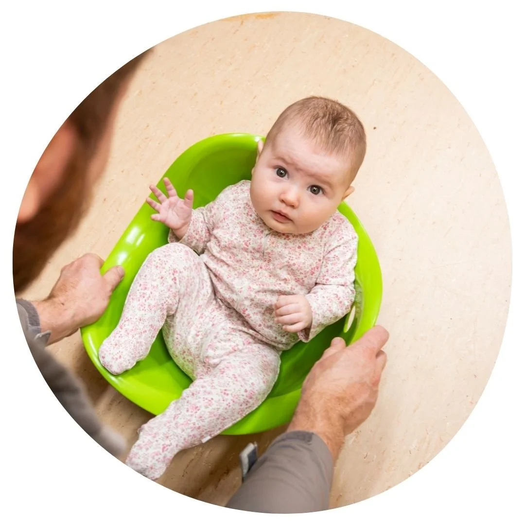 Baby sitting in green wobble seat