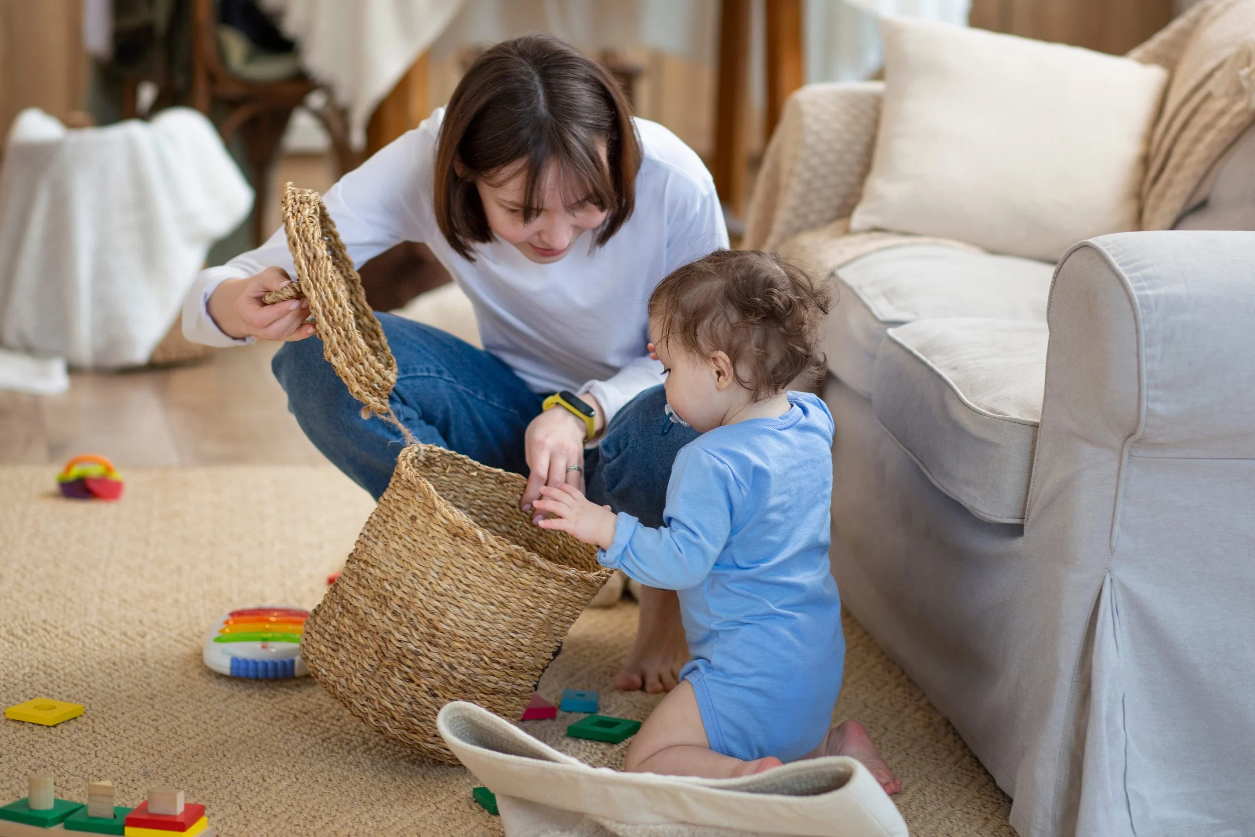 Nanny playing on the floor with baby