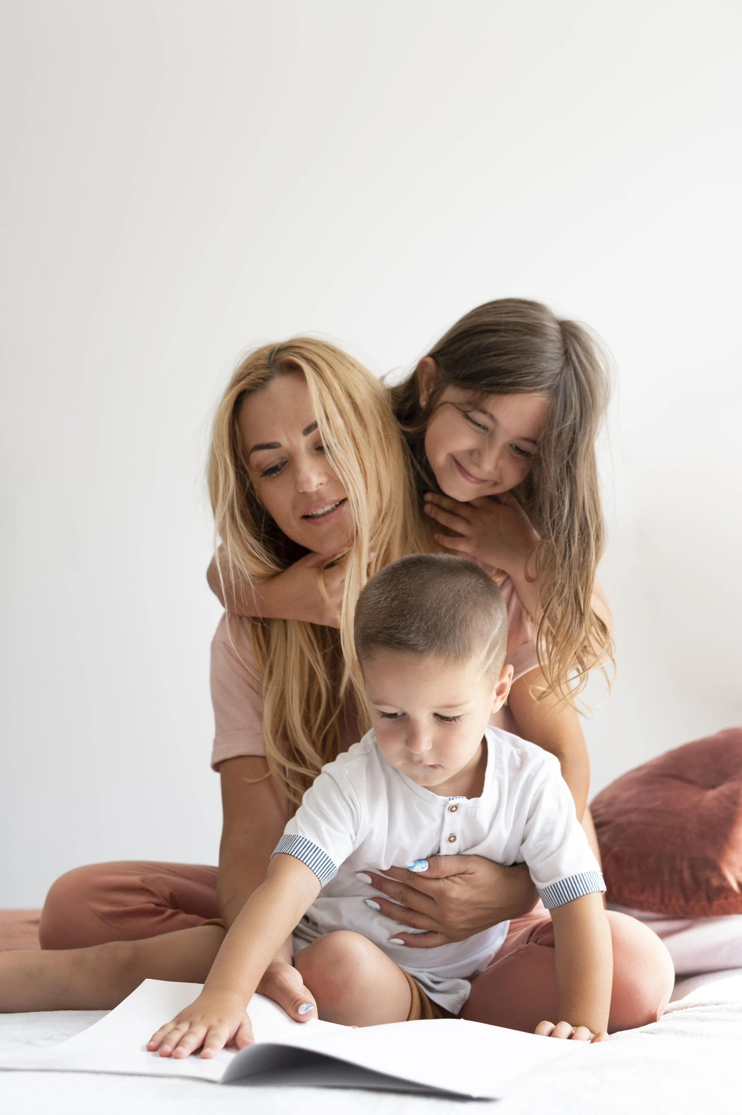 Babysitter reading with two children.