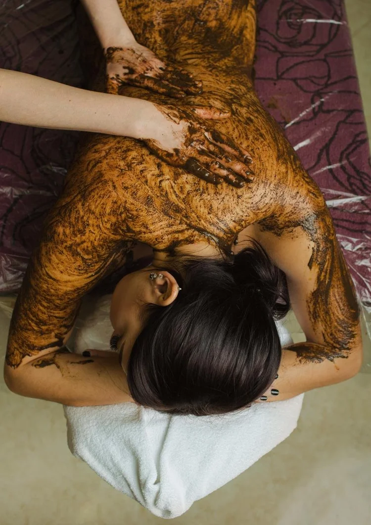 Exfoliating body scrub being applied to a client’s back
