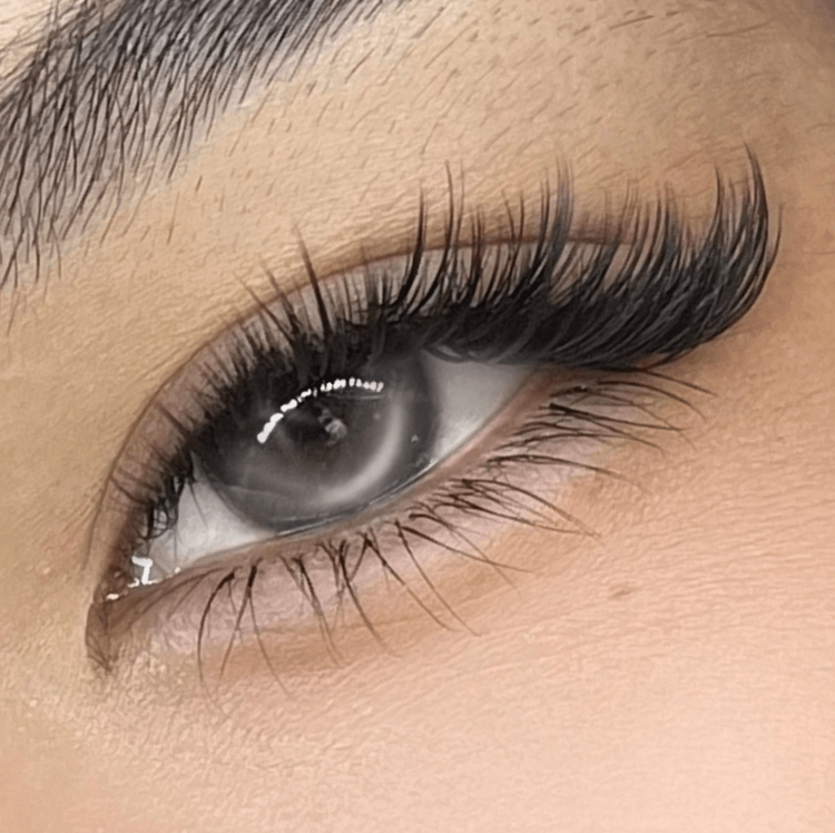 Foxy lash extensions, longer towards the outer corner, on a grey eye