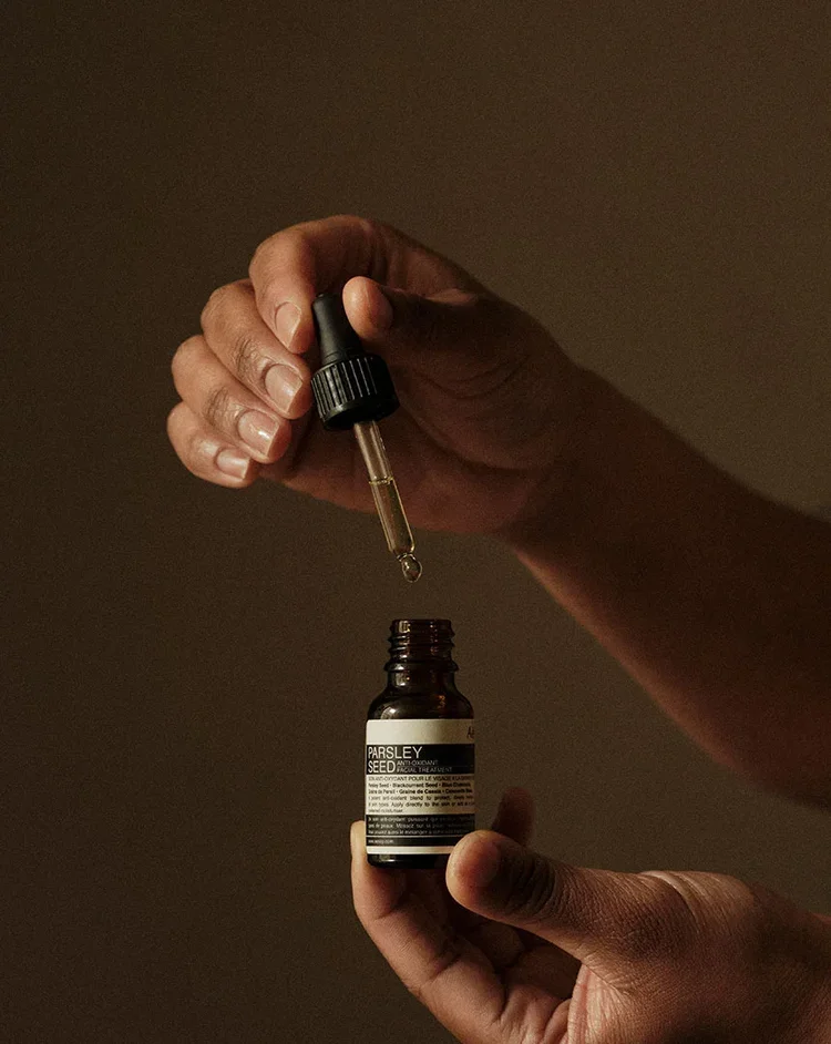 Aesop facial oil drawn up in a glass dropper