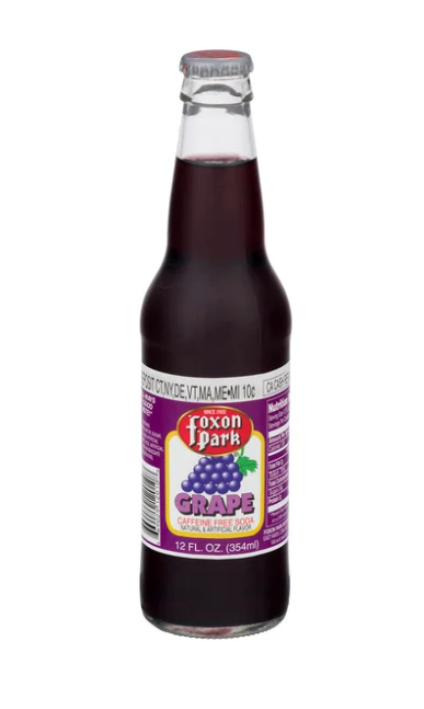 A glass bottle of Foxon Park Grape caffeine-free soda with a purple label, showing a bunch of grapes and the brand name.
