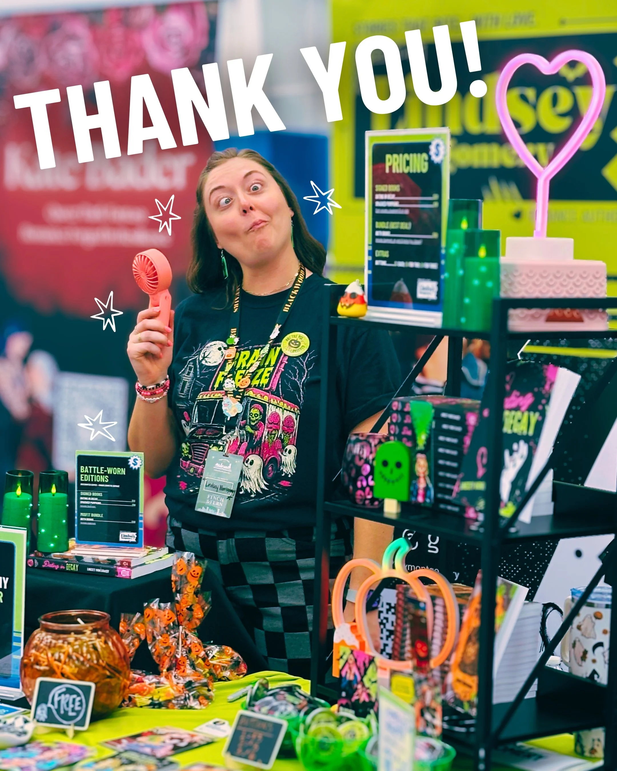 Picture of Lindsey Montgomery at booth at Pages of Glass doing a funny face. Text reads Thank You!