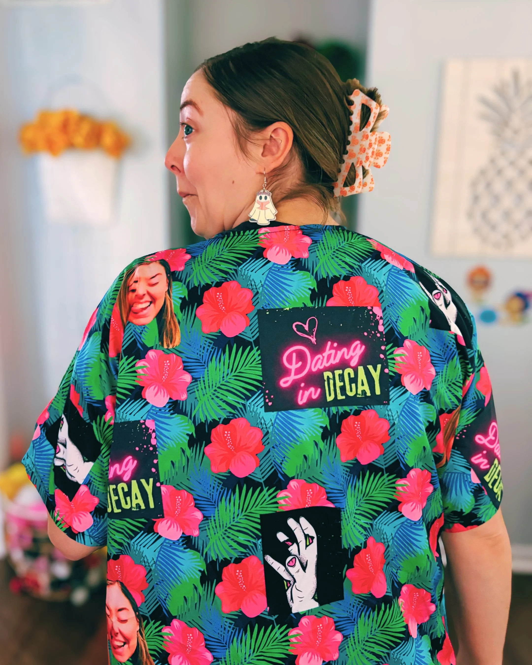 Author wearing a hawaiian shirt with images of Dating in Decay and her face all over it.