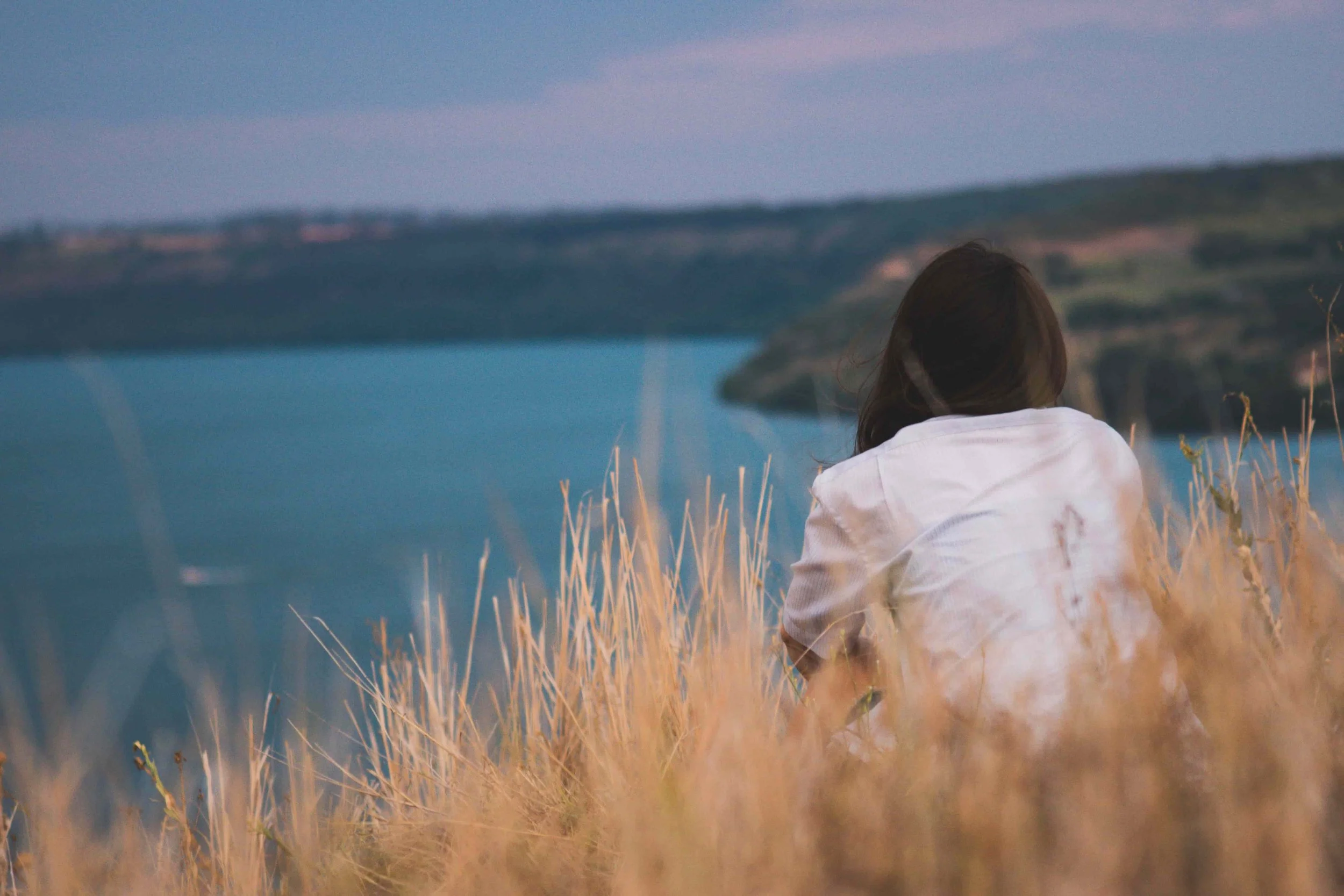 woman sitting in peaceful coastal setting