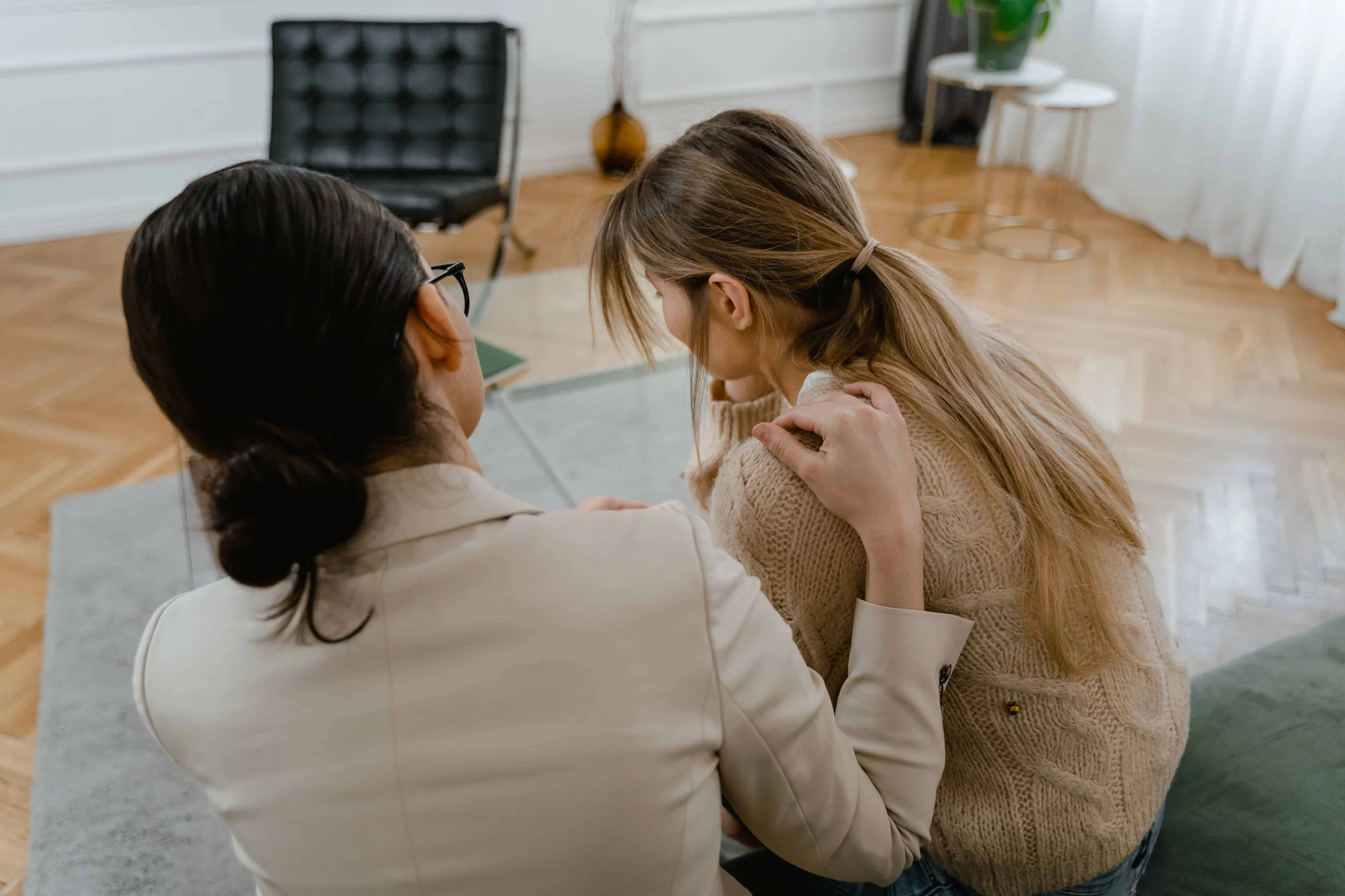 What Trauma-Informed Therapy Really Looks Like-Woman comforting another woman in a therapy office