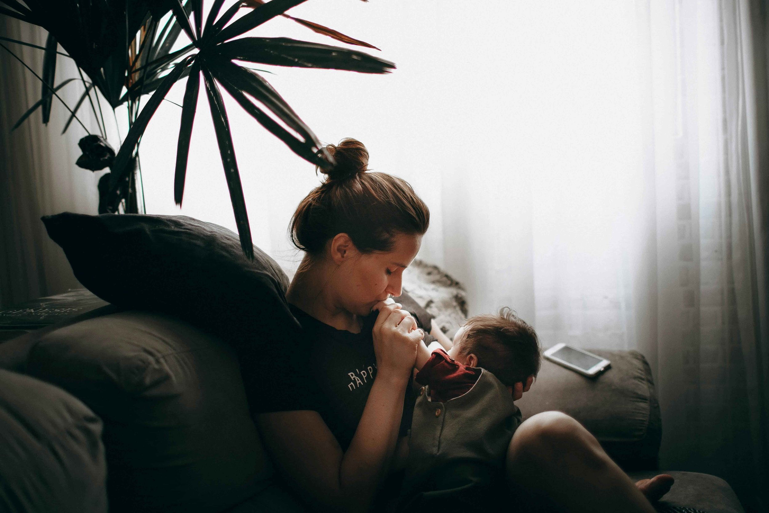 Support Options for Moms During Pregnancy & Postpartum-Mom kissing newborn baby's hand