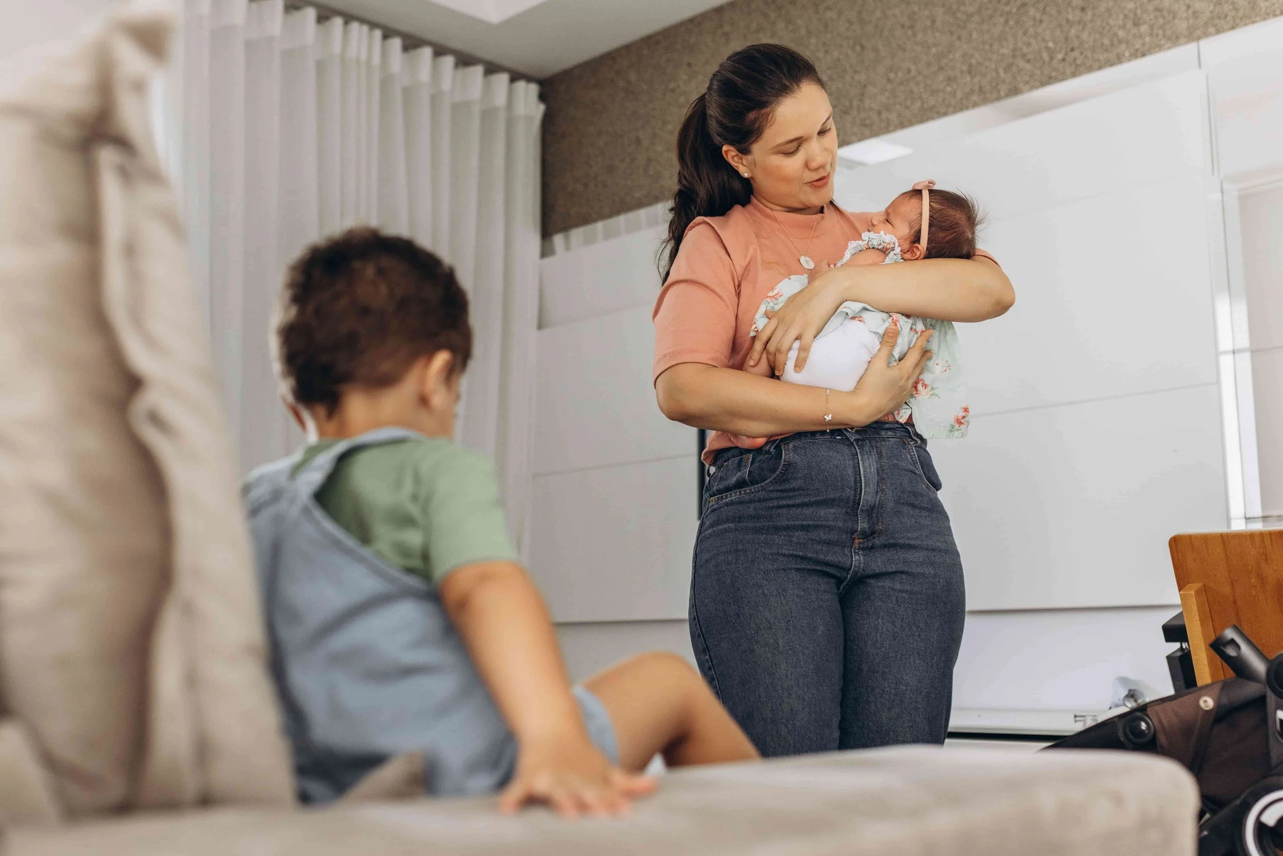 When to Seek Professional Support During Pregnancy or Early Motherhood-Mom holding a baby with a toddler sitting close by