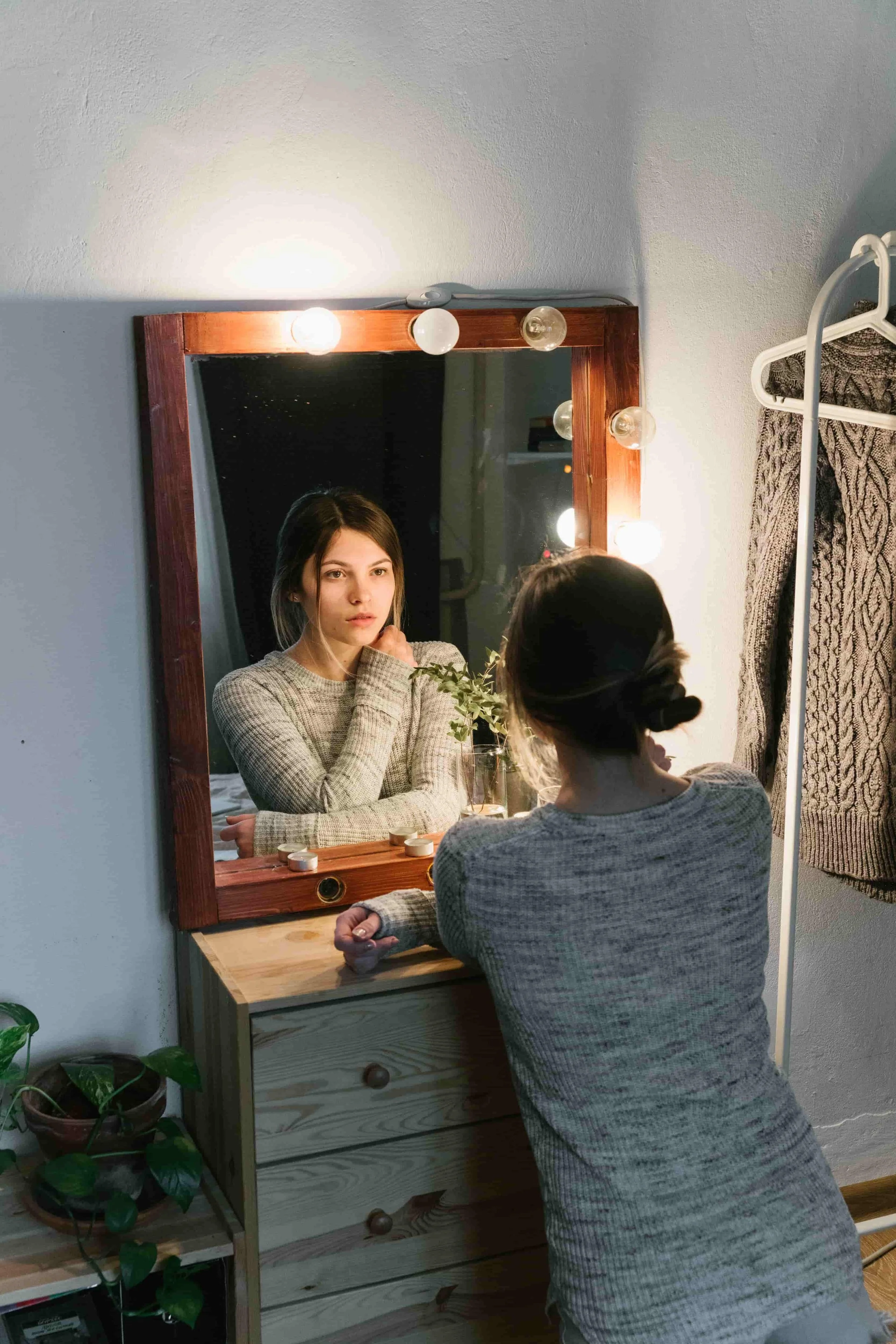 EMDR Intensives vs. Weekly EMDR Therapy: Which Is Right for You? Woman looking in a mirror