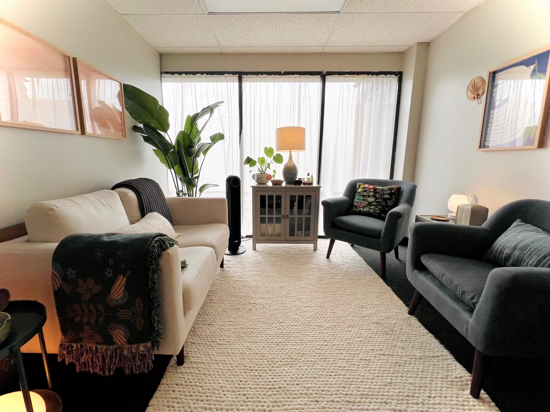 How Motherhood Can Surface Past Trauma- office with chairs, couch, rug, and plants