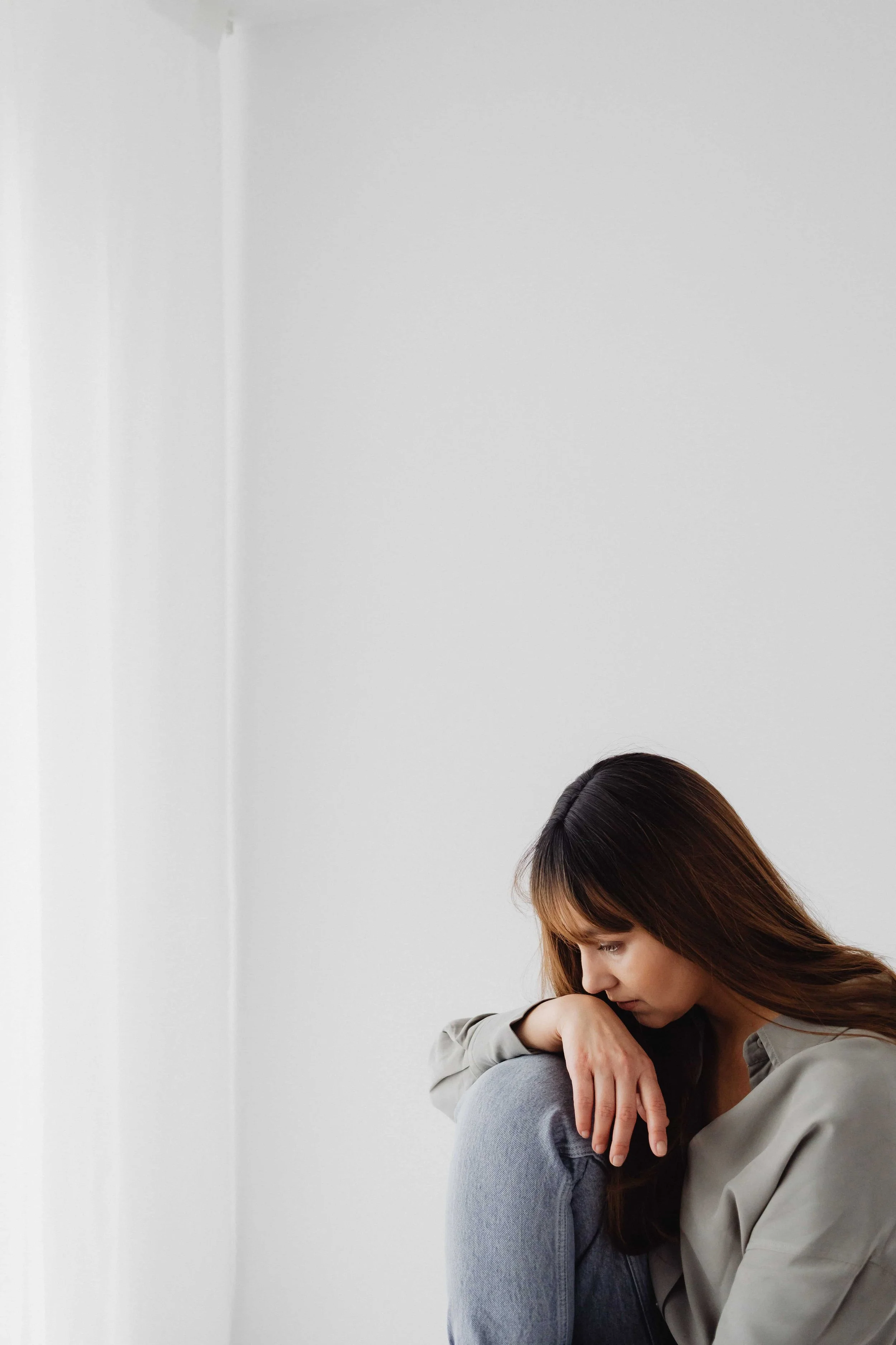 When EMDR Is Often Recommended in Trauma Treatment- Woman sitting pensively on the floor