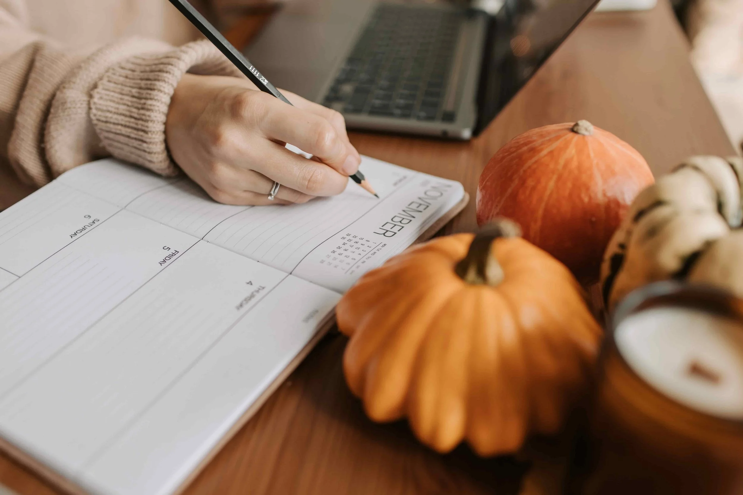 EMDR Intensives vs. Weekly EMDR Therapy: Which Is Right for You? - Woman writing in calendar sitting at a table