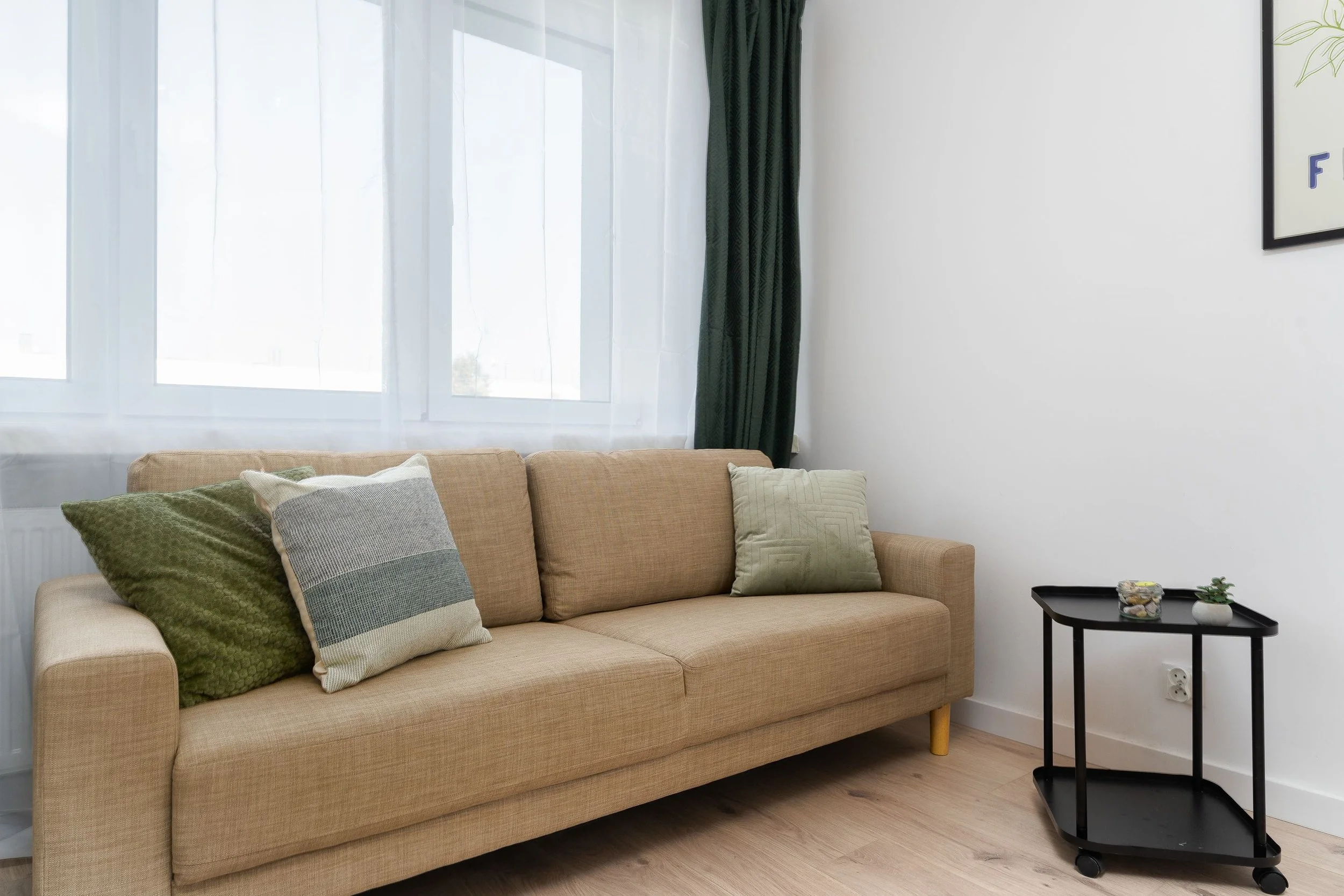 counseling office with couch, side table, and large window