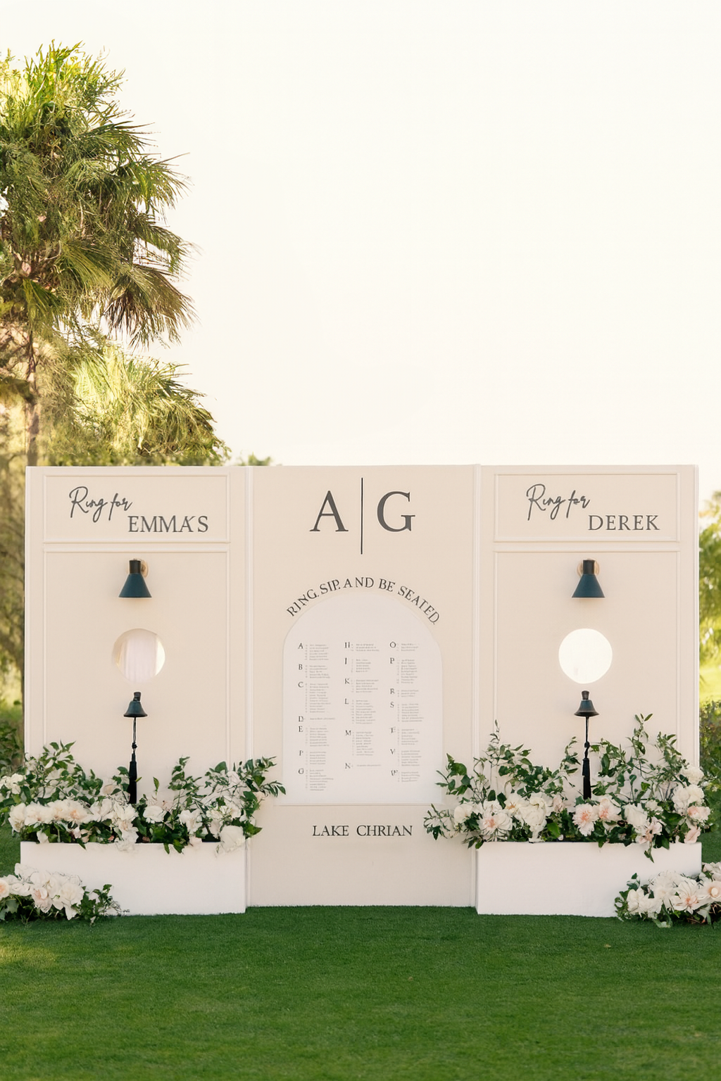 Interactive three-panel drink wall and seating chart with custom signage, bell cutouts, and classic white frame.