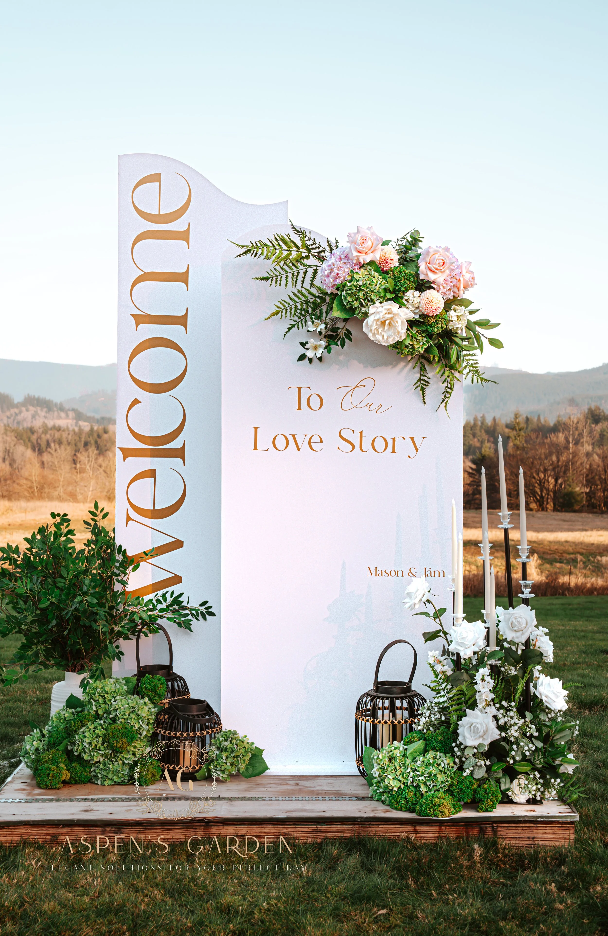 Modern arched welcome sign duo in white and blush, with floral accent and “Welcome to Our Love Story” message.