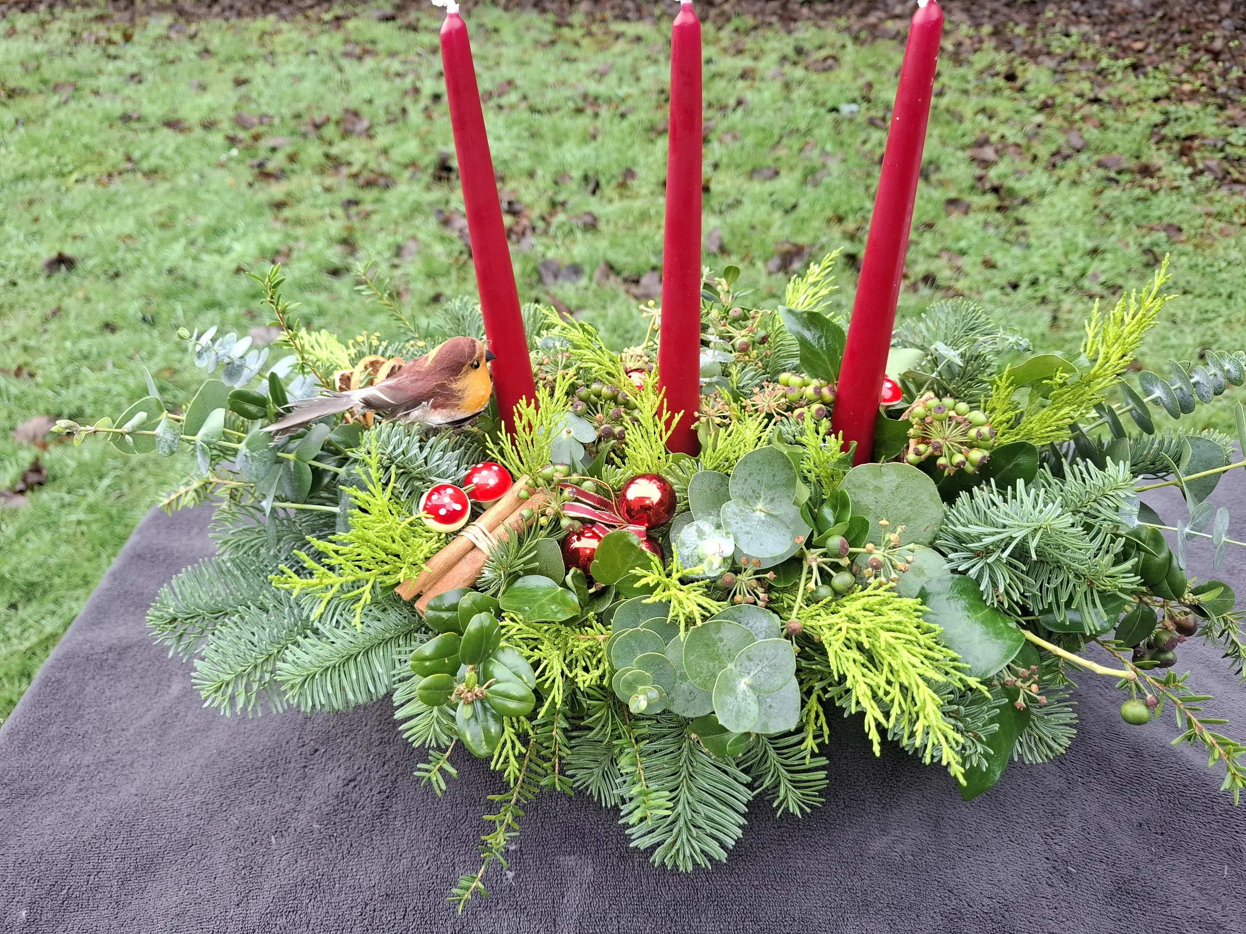 3 red candle table arrangement with robin_20251213_113631.jpg
