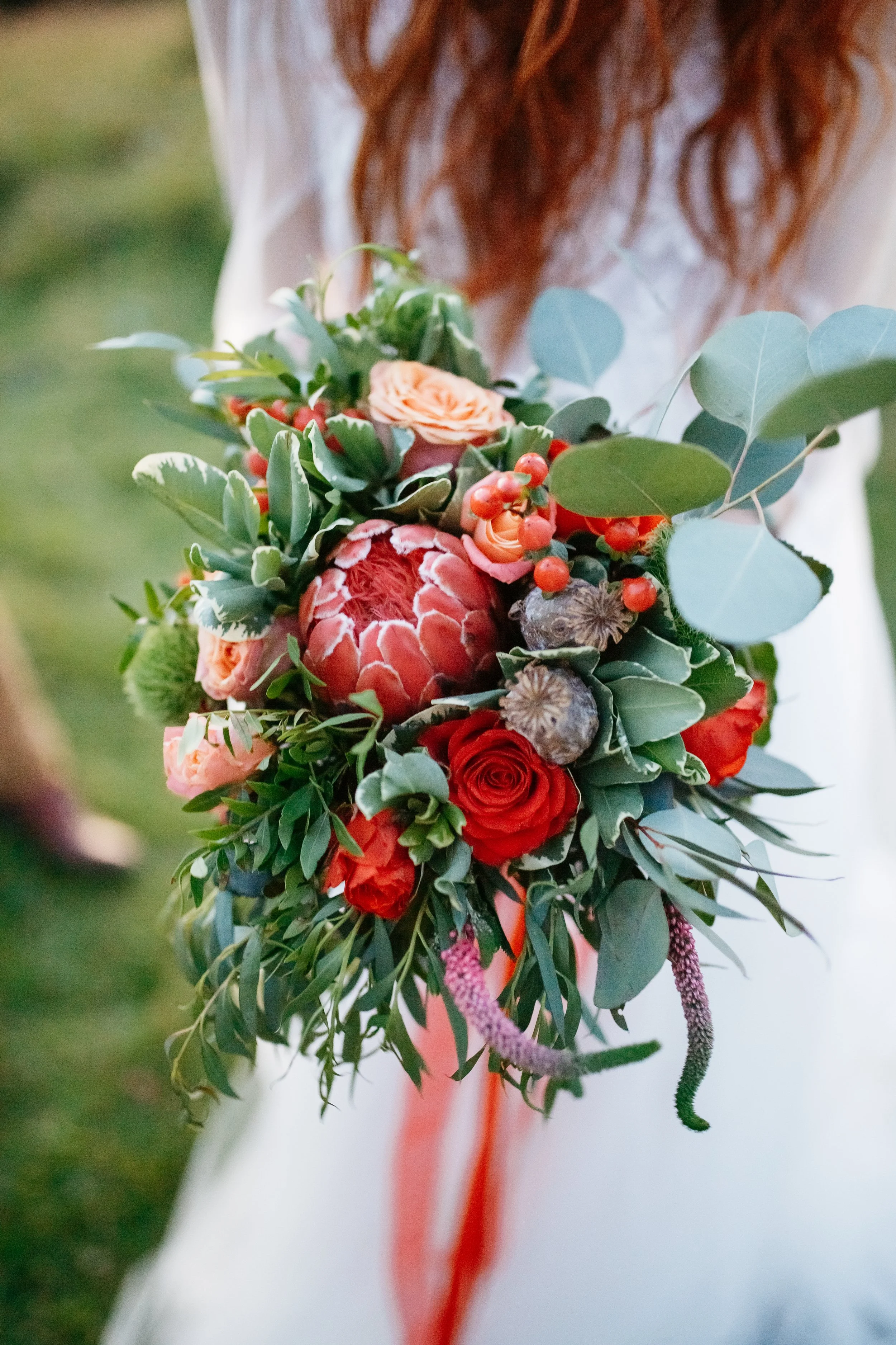 red-haired-bride-holds-perfect-wedding-bouquet-made-red.jpg