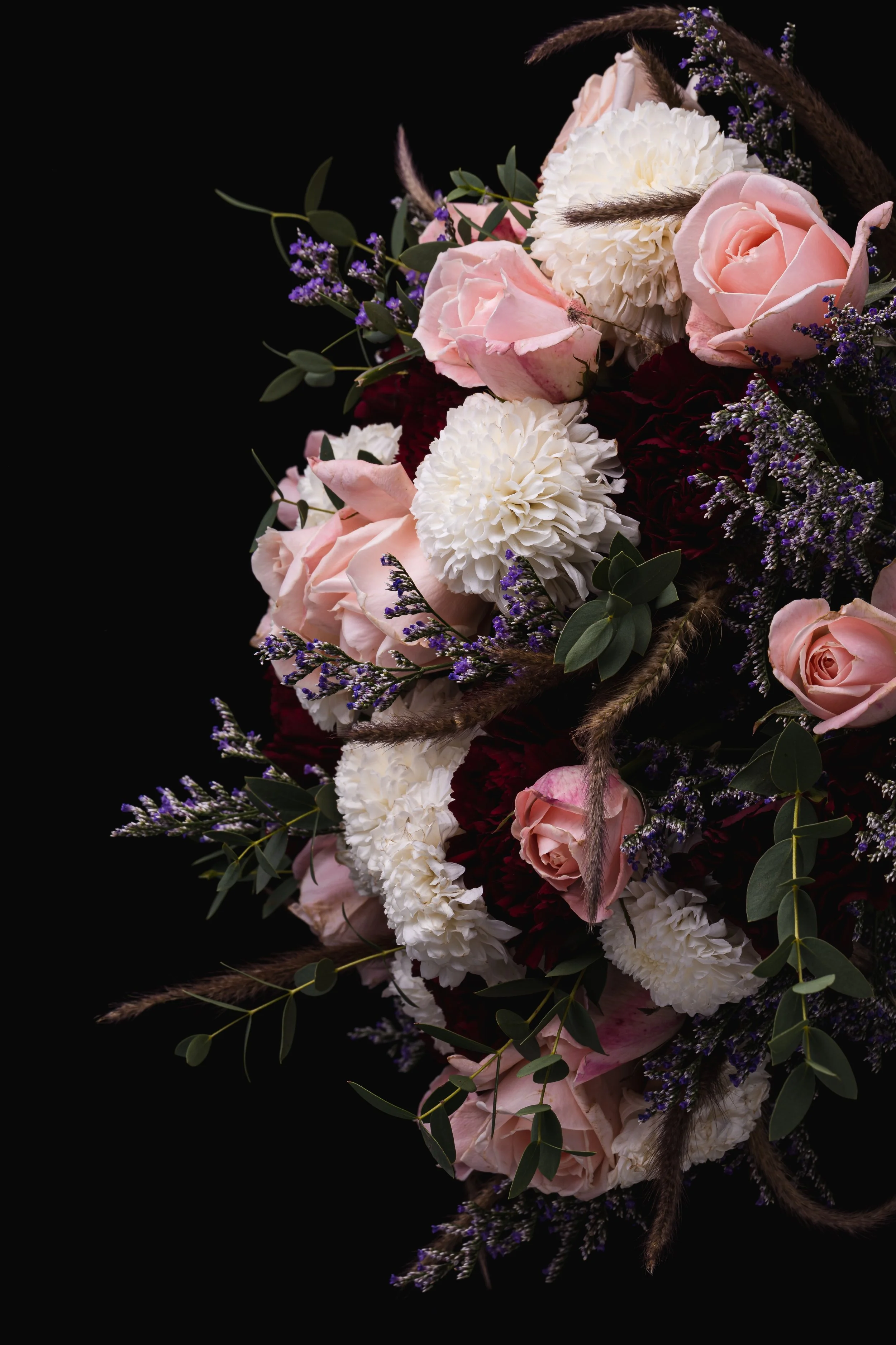 vertical-shot-luxurious-bouquet-pink-red-roses-white-dahlias-black-background.jpg