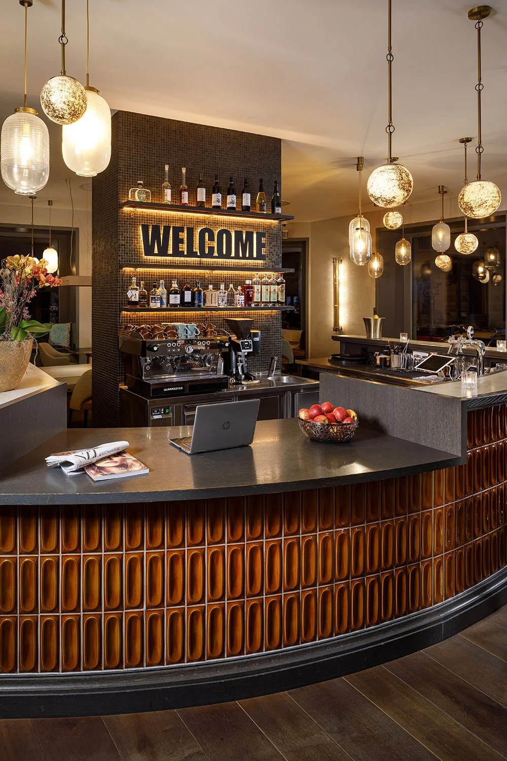 Modern reception area with a warm colour 
concept and the lettering Welcome