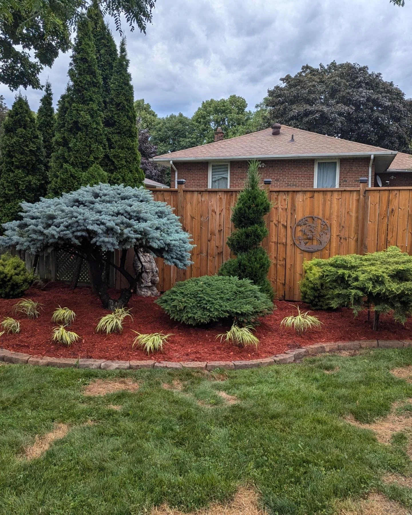 Transforming green spaces into serene sanctuaries 🌿✨ 

This client is Polish 🇵🇱 and the red mulch is a reminder of her mother who loved it so we didn't mind refreshing it with 165 new bags. 

In total we added 3 yards of soil, 165 bags of mulch, a